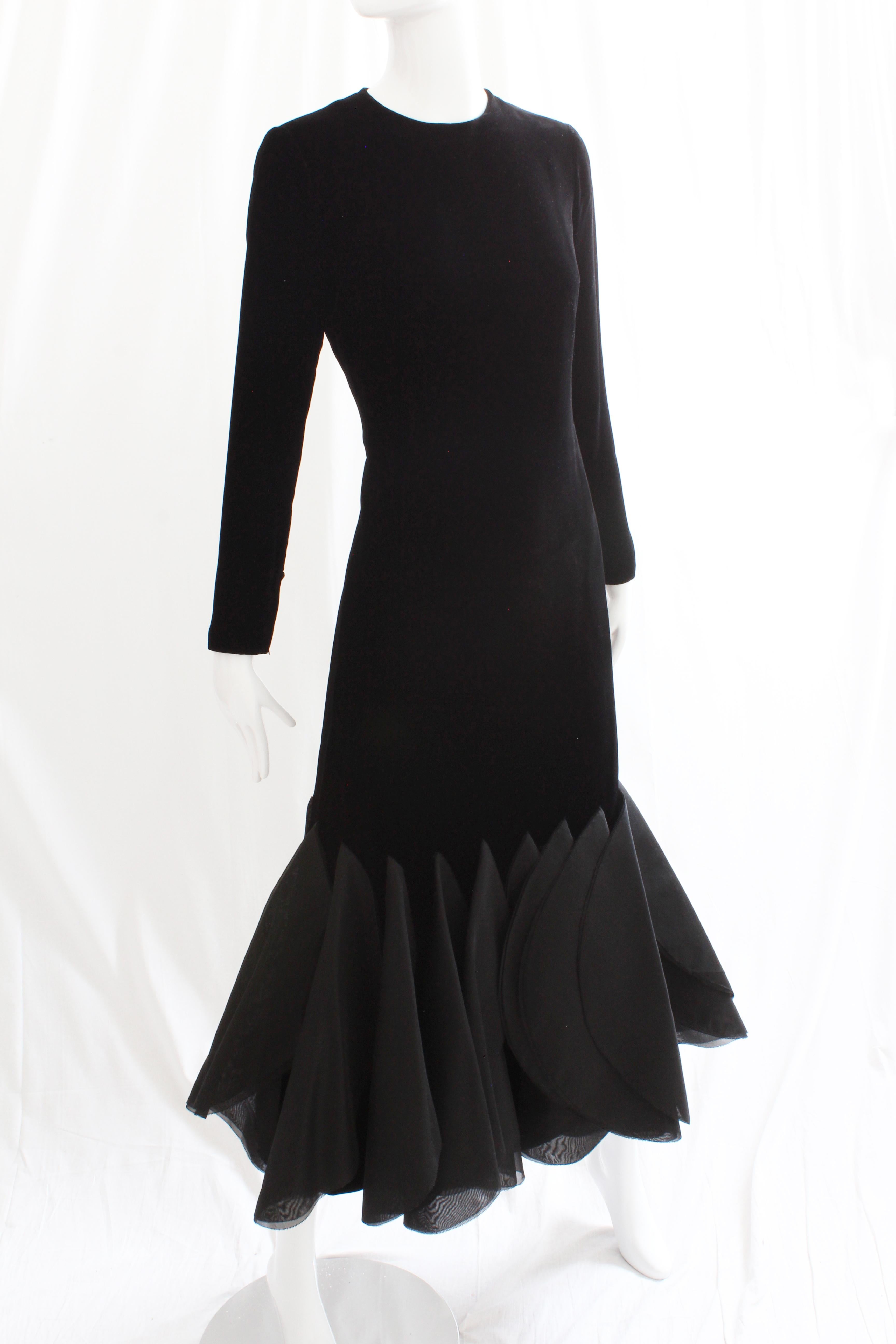 This incredibly rare evening gown was designed by Pierre Cardin in the late 1960s for his Space Age and Futurism collection.  Made from what we believe is silk velvet (no content label), it features sheer circular fins at the hem, made from double