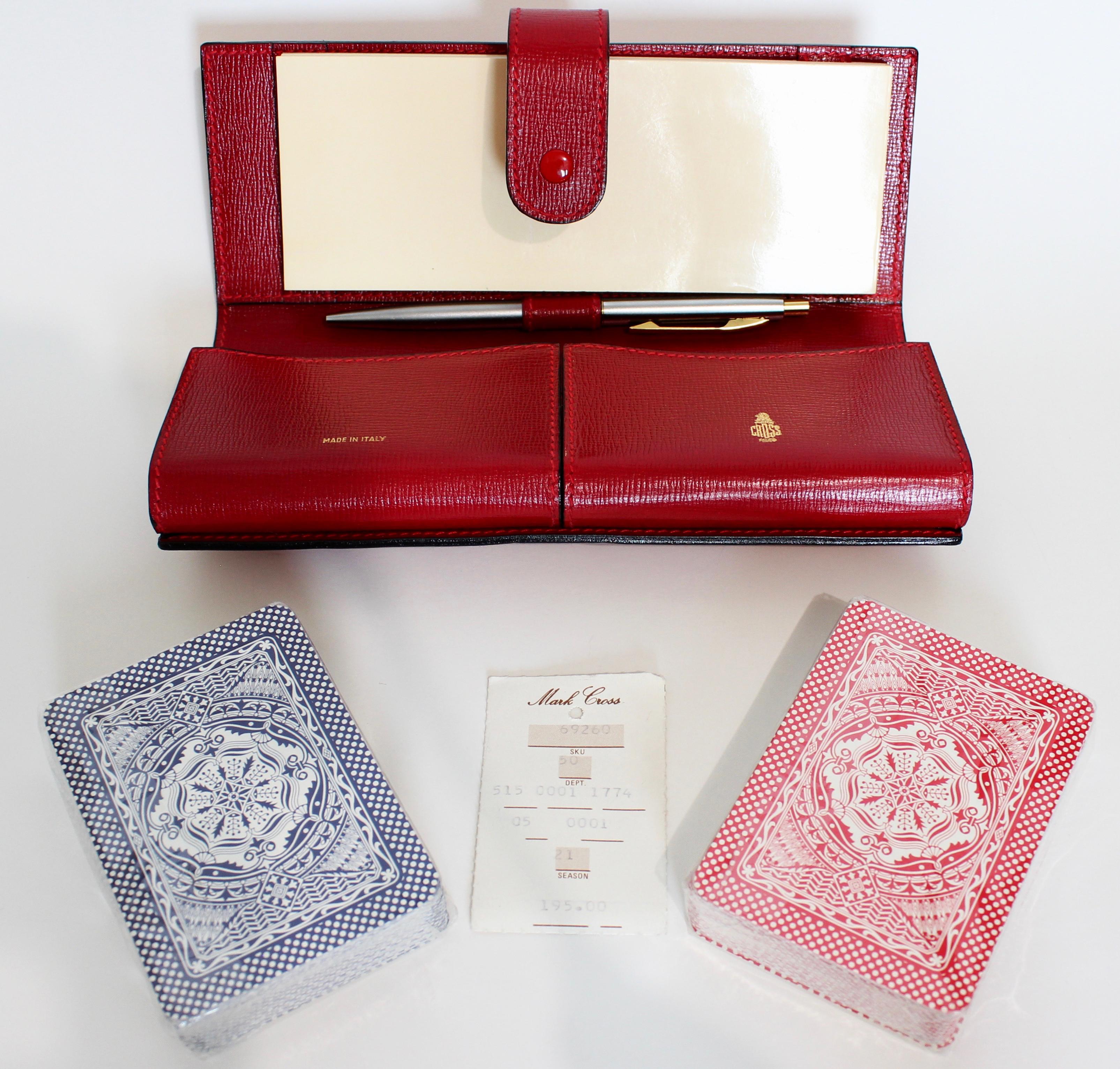 Looking for a unique gift idea? This red saffiano leather travel playing card game set fits the bill.  Made in Italy for Mark Cross, the set includes the brilliant red leather game case, two decks of playing cards (still factory wrapped), a pen and