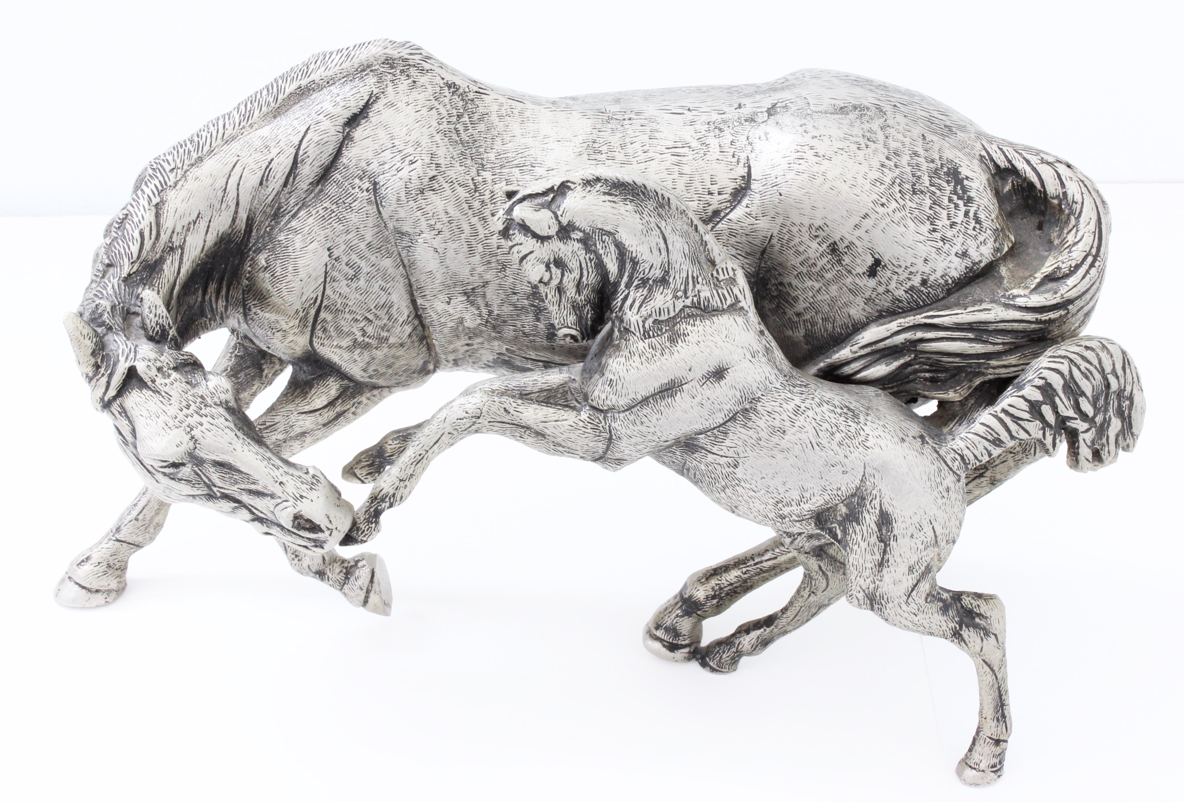 This lovely figural sculpture was made by Gucci Italy, most likely in the 1970s.  Made from a silver plated metal, it features a wonderful mare with her playful foal.  Perfect for the collector, interior designer, equestrian or animal lover, this