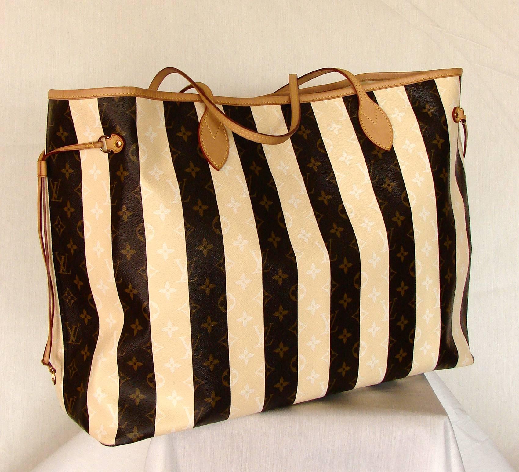 The Louis Vuitton Rayures line was inspired by the à rayures or striped steamer trunks introduced by the house before the turn of the century.  This piece was created in 2011 as a limited edition for VIP clients and is a much larger version of