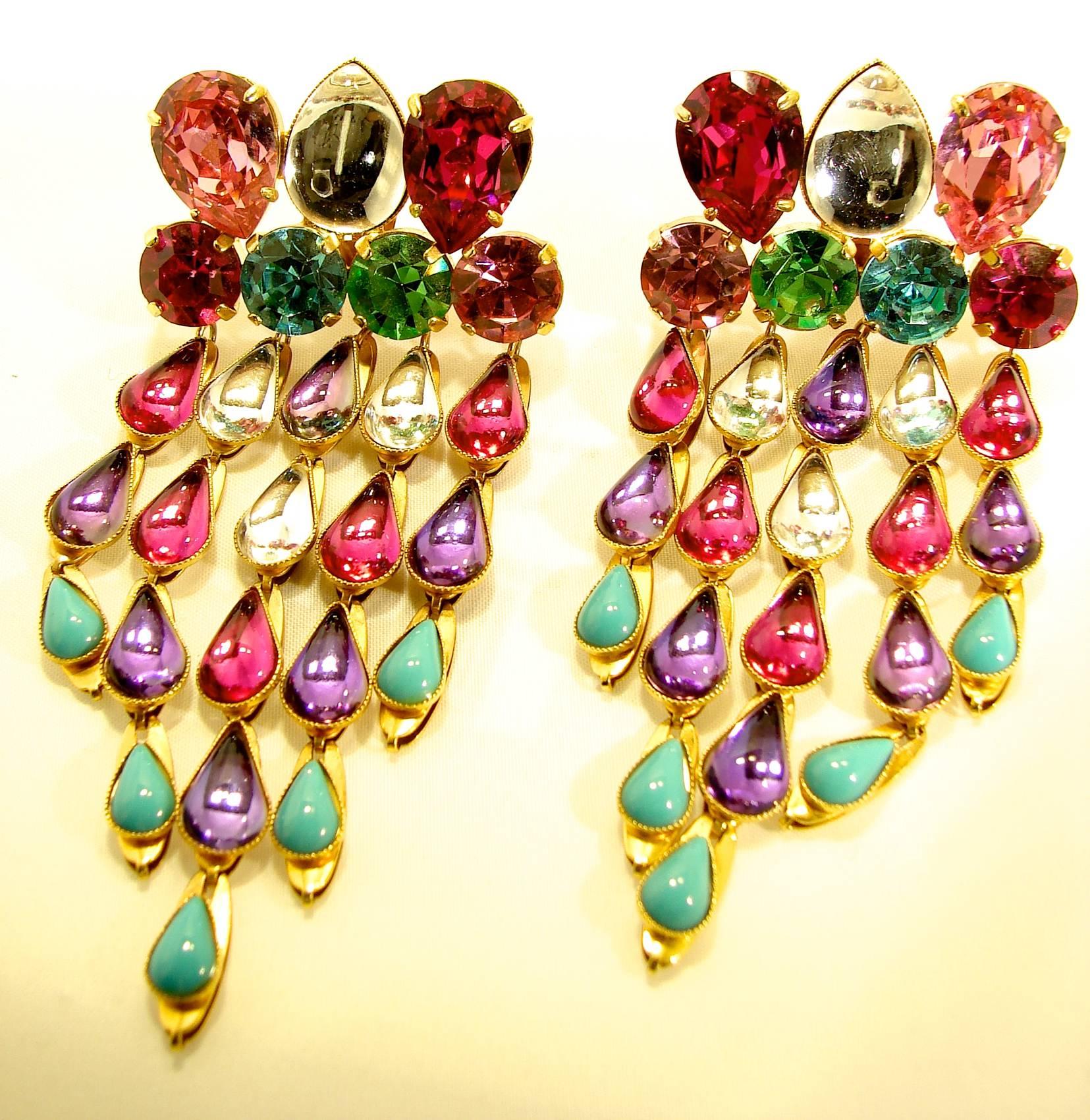 Clip style earrings circa late 1970s for Yves Saint Laurent's Rive Gauche line feature a row of sparkling rhinestones and glass cabochons, with dangling strands of glass tear drops in shades of turquoise, rose pink, amethyst and white.
This