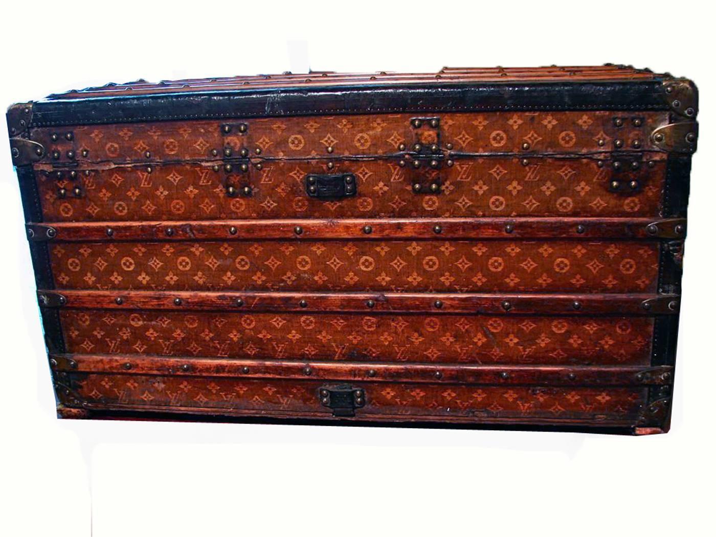 This iconic steamer trunk dates to the early 1900s and is made from Vuitton's monogram canvas (handwoven, which is typical of trunks made prior to 1905), leather trim and brass hardware & handles.  The interior is lined in cream fabric and features