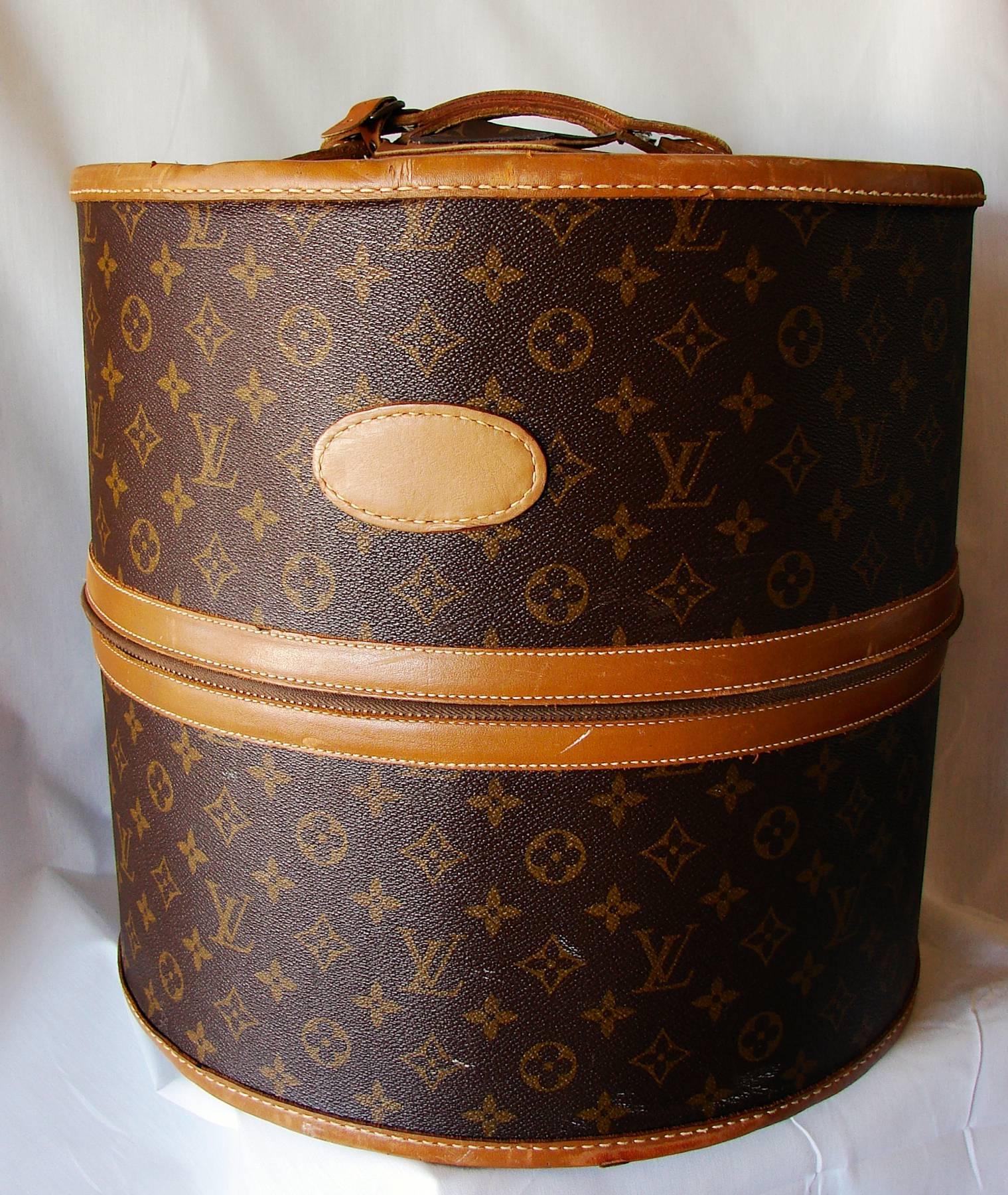 This large hat or wig box was manufactured by The French Company USA under special license by Louis Vuitton, long before Vuitton has a boutique presence in the United States.  Made from their monogram canvas, it features saddle leather trim and