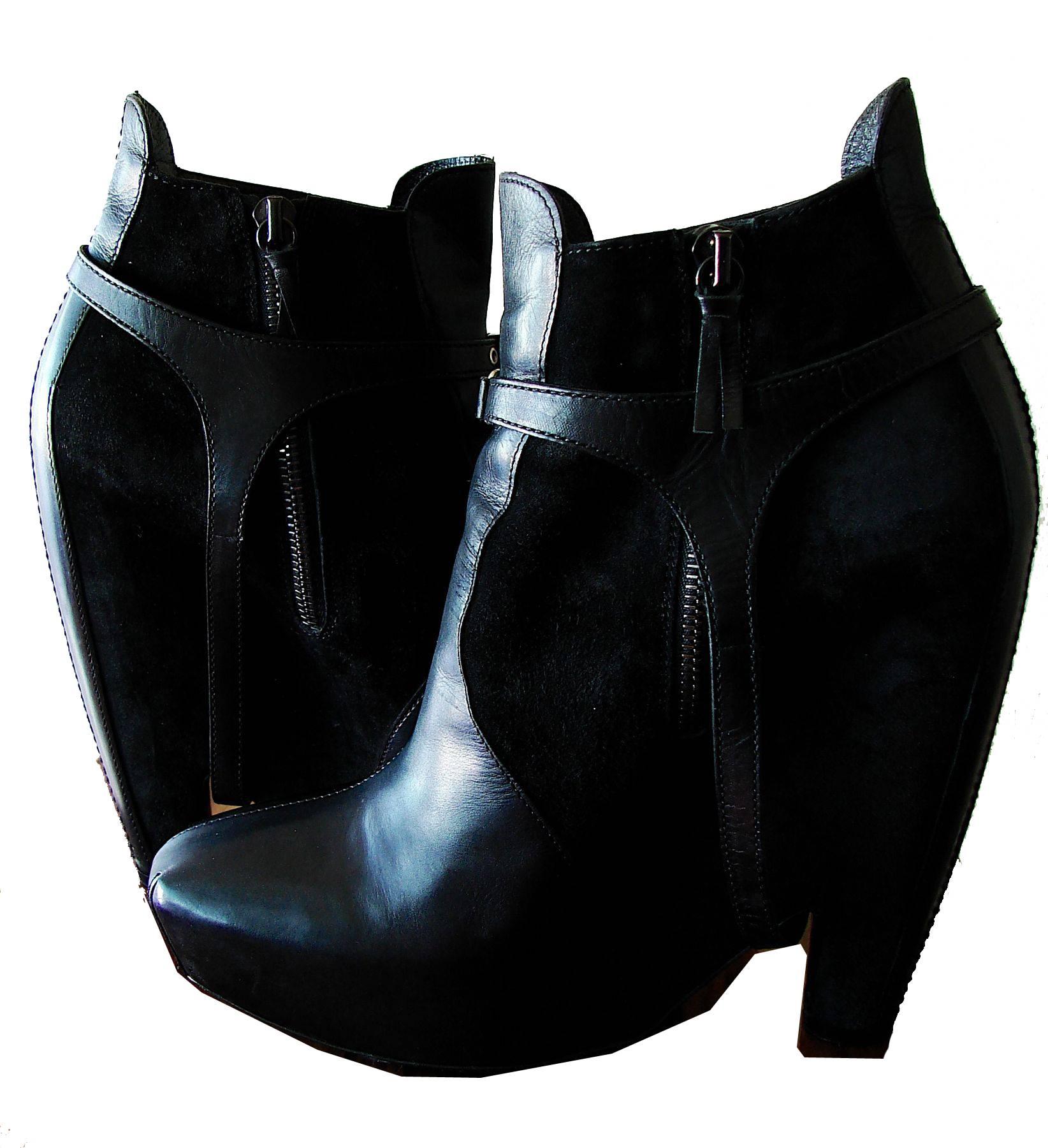 These short platform boots from Balenciaga were part of the 2006 collection and sold out quickly.  Made from black calfskin leather and suede, they feature a removable leather harness, side zipper, a 2
