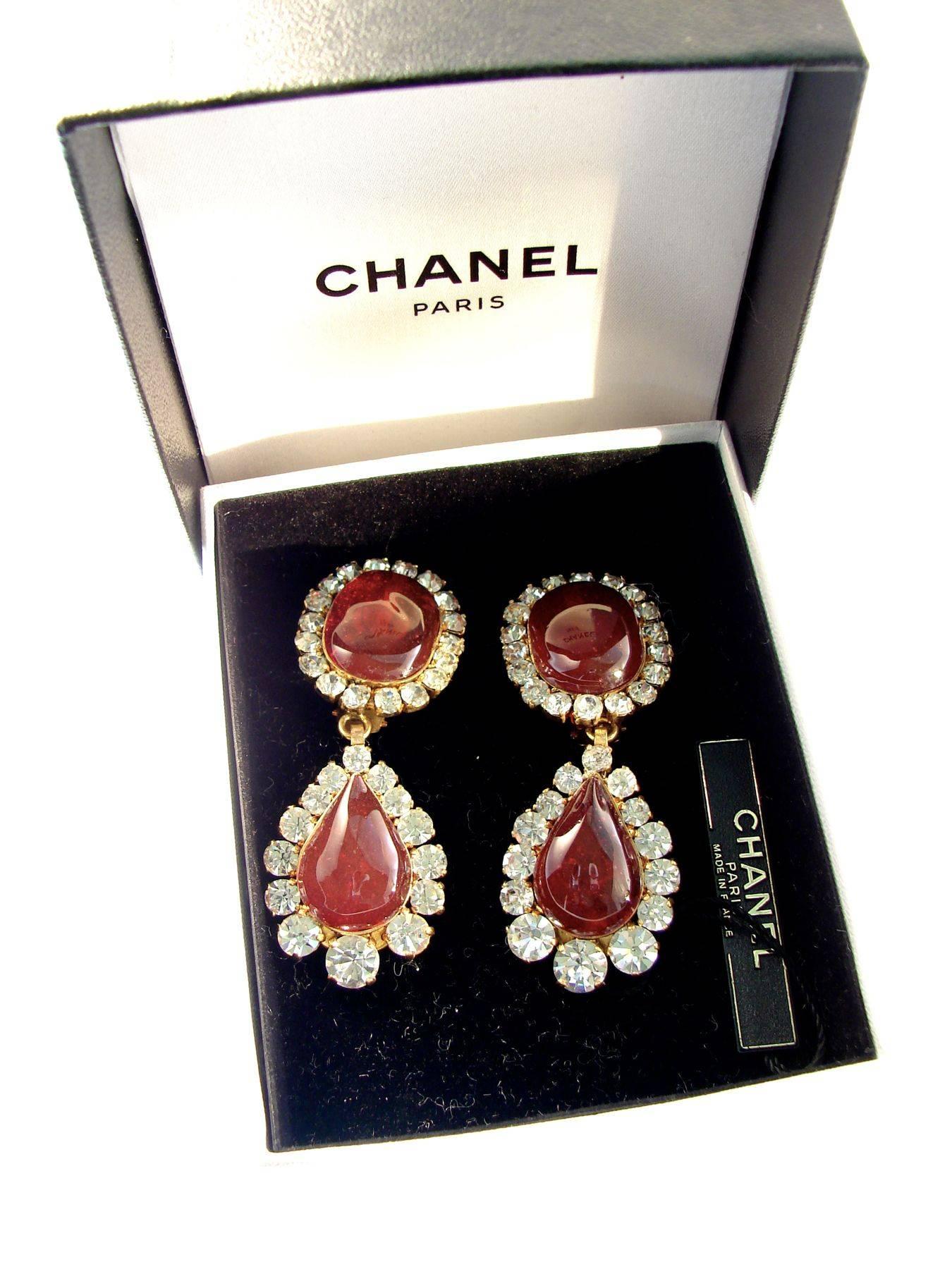 These fabulous Chanel earrings were created in 1995 as part of the Season 29 collection by Victoire de Castellane for Chanel.  Made from a gold metal setting, they feature large rose-colored poured glass cabochons surrounded by sparkling diamante