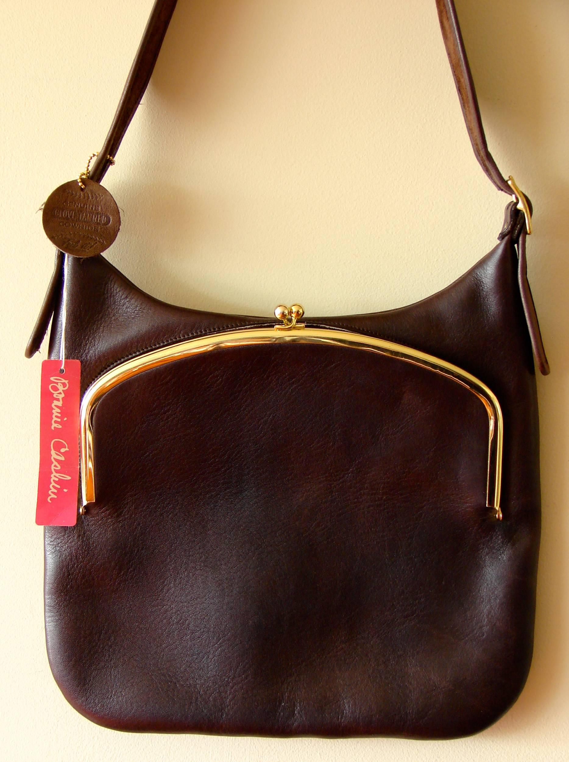 Here's a hard to find leather bag from Bonnie Cashin for Coach Leatherware.  This piece is deadstock - never used and in excellent condition.  It features the very hard to find baseball shaped leather hang tag as well as Bonnie's pink hang tag