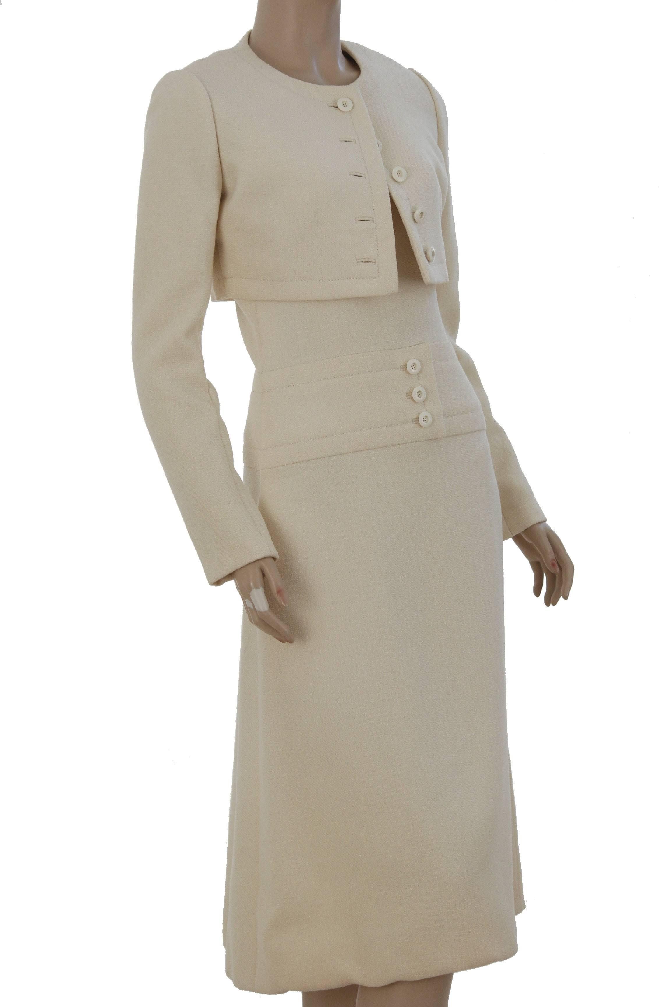 We love this minimalist ensemble from GALANOS, circa 1960s.  This incredibly tailored set features two pieces: a cropped jacket and a sleeveless dress, made from a lightweight wool in cream (there's no content label). Both pieces are fully lined and