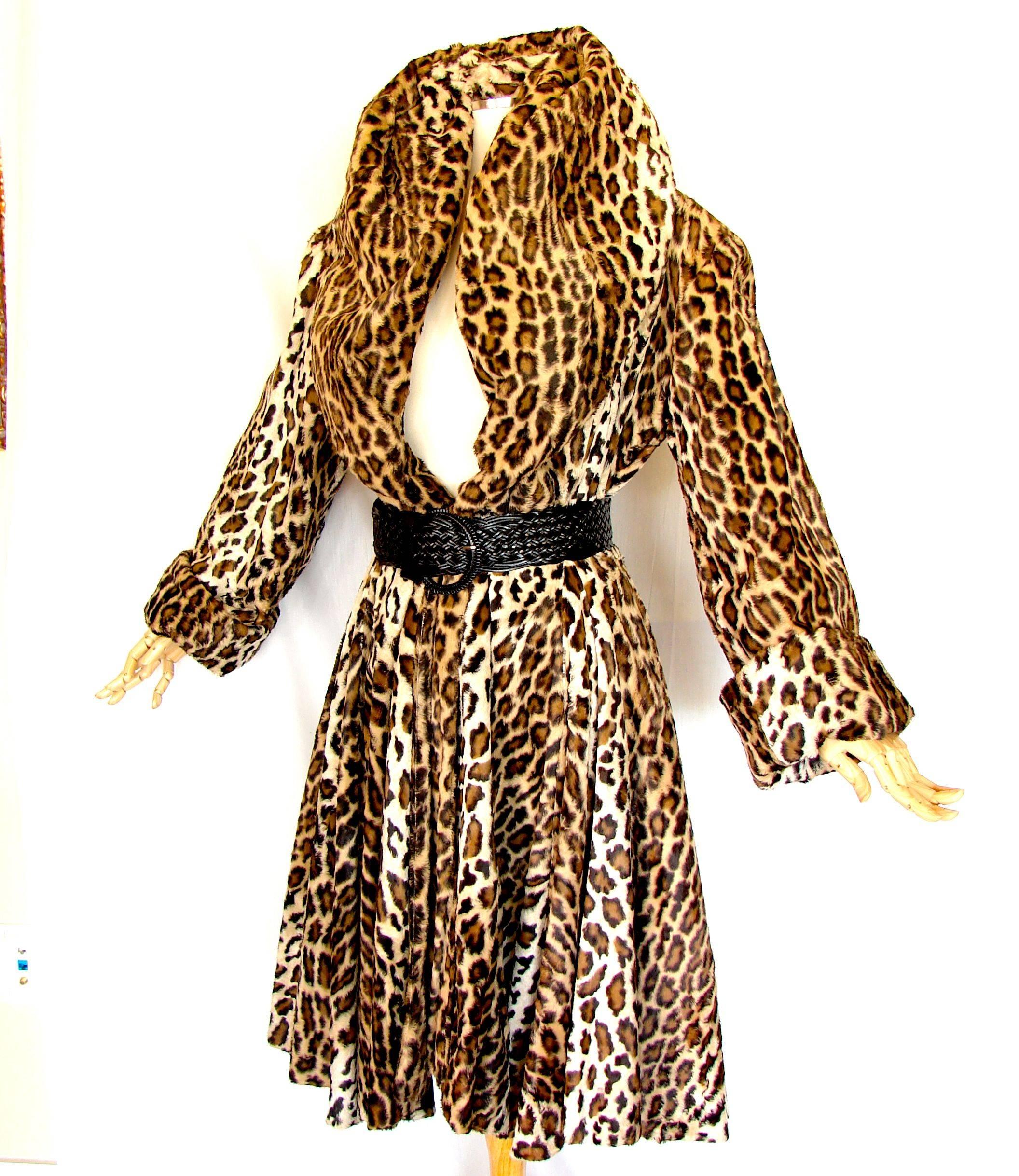 This coat is simply incredible! Made by Norma Kamali for her OMO line in the early 1980s, it features a huge shawl collar that can be worn propped up, over the shoulders or even as a hood over your head.  Lined in black silk, this coat is
