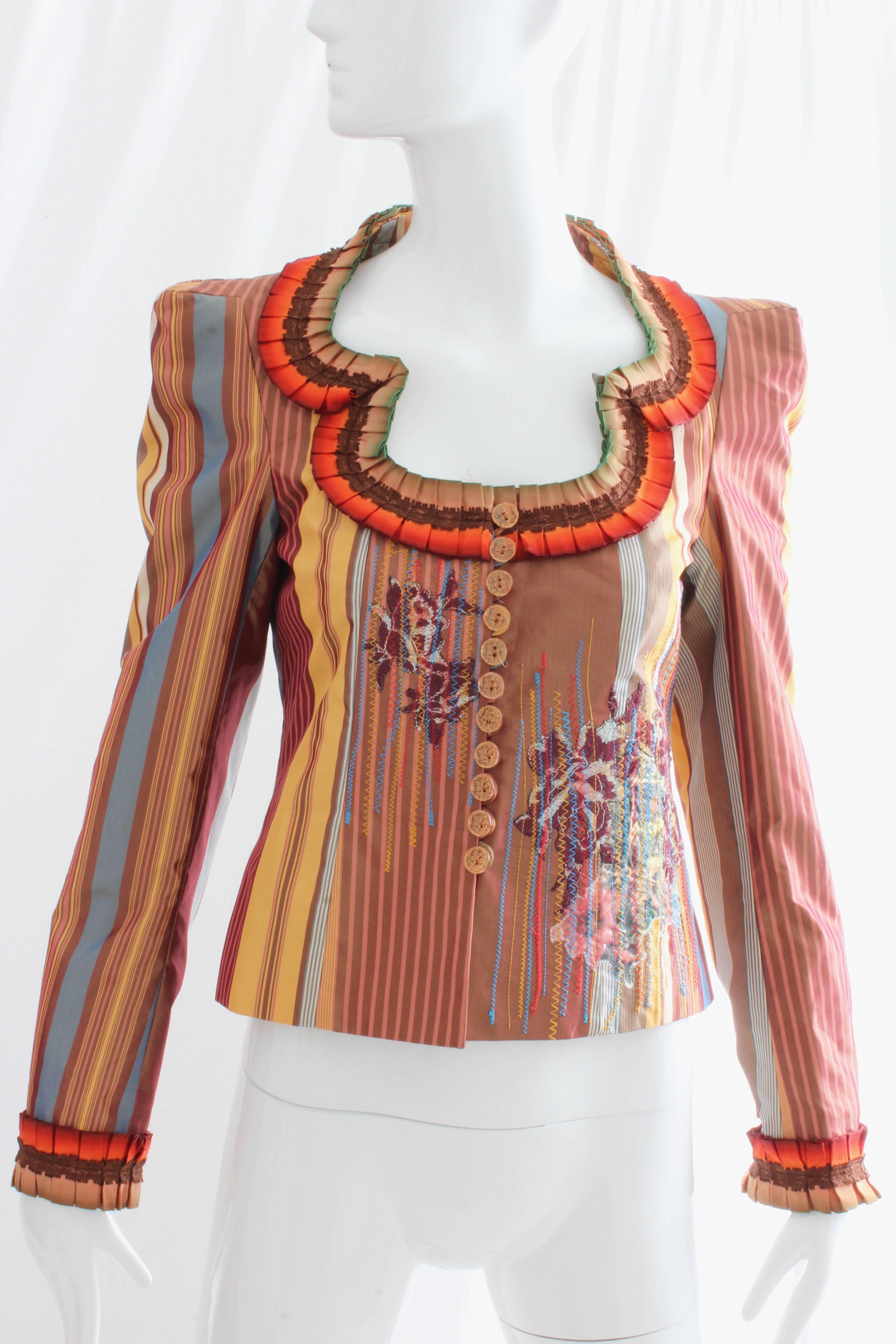 This fabulous jacket is from Christian Lacroix.  Made from 100% silk, it features a cacophony of colors, textures, photos and embroidery, a signature of the designer's earlier work.  This piece is dead stock, and still retains its tags.  In pristine