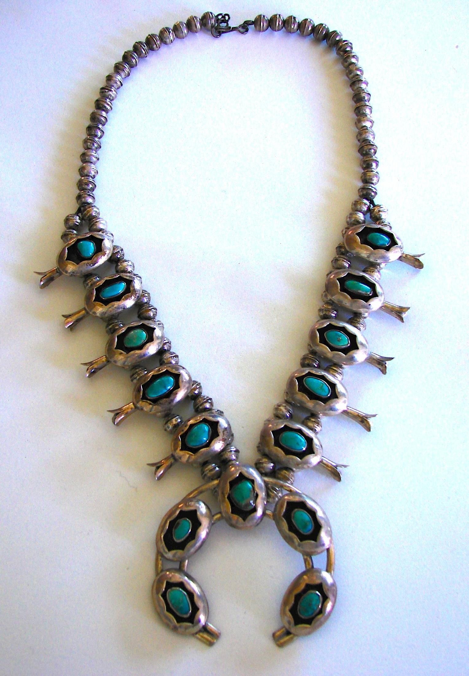 Massive vintage necklace from the 1970s features sterling silver and turquoise.  The necklace is about 23in long without the naja. The naja is about 2.5in diameter.   Unmarked.  Preowned/vintage with some tarnish to the silver, most notable on