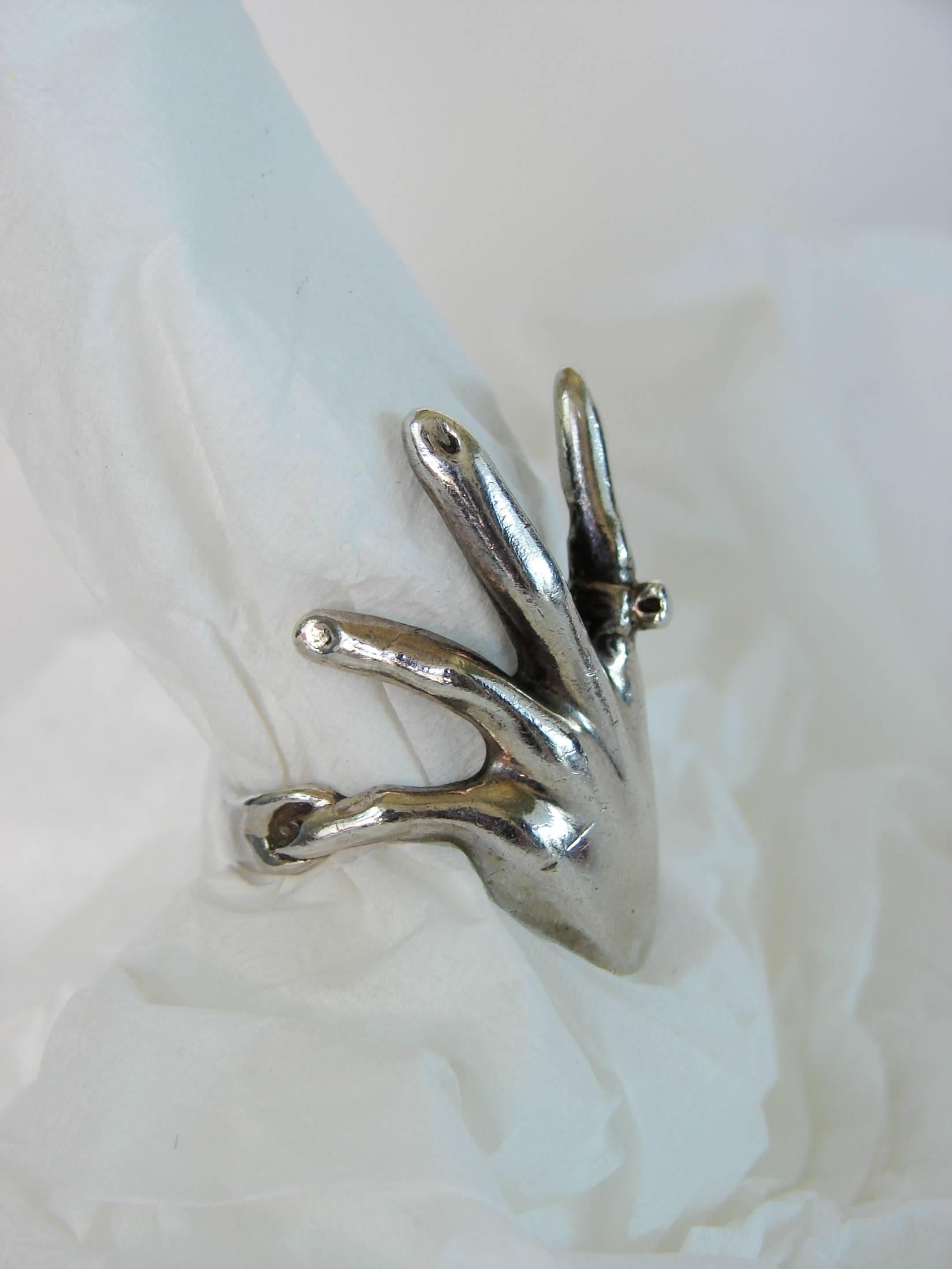 This sterling ring was custom made in the 1970s and is shaped as a human hand, complete with its own ring! One-of-a-kind and substantial in size (1.25