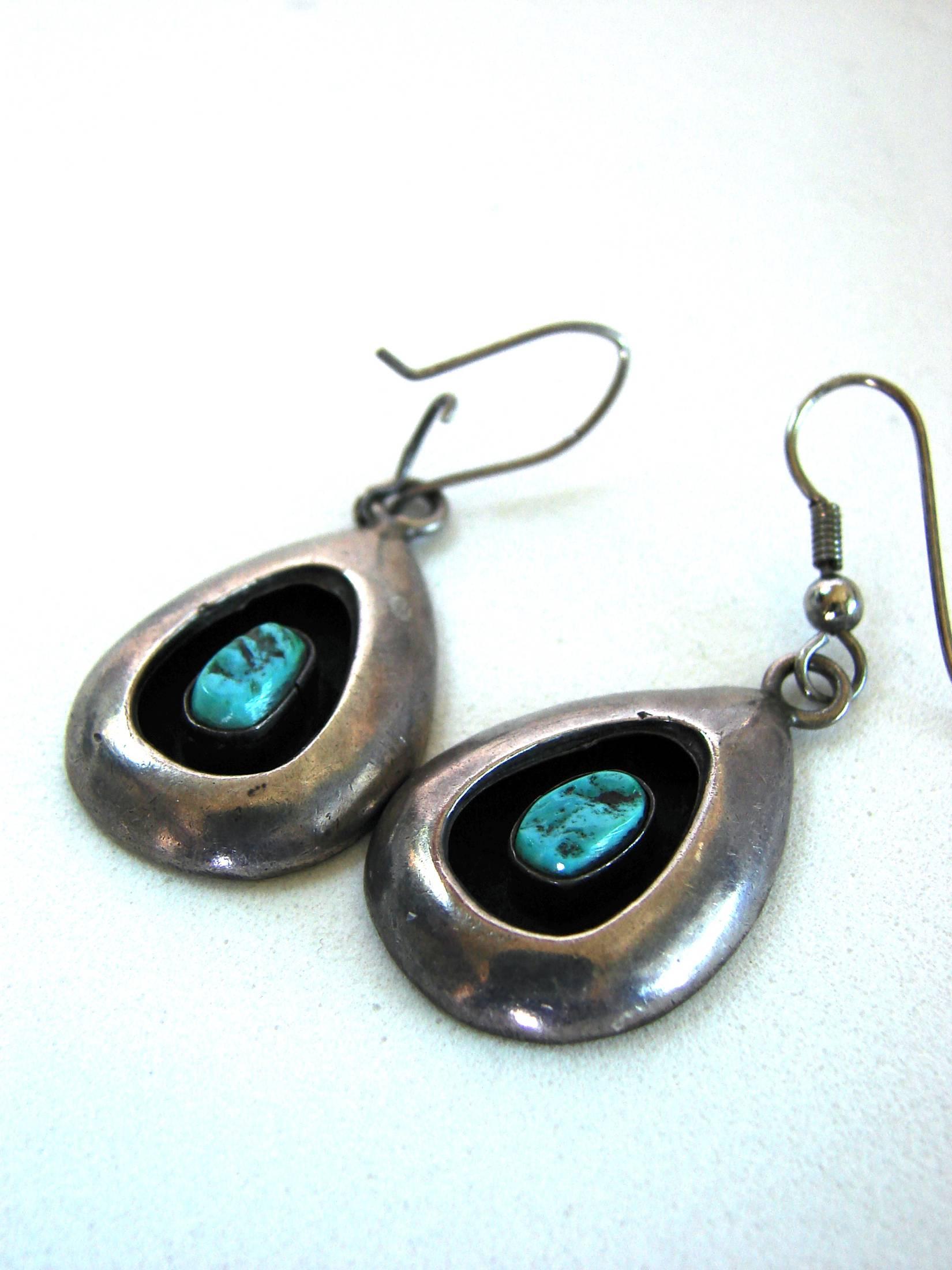 A pair of sterling and turquoise earrings from the mid 1970s. Preowned/vintage with scratching and some tarnish from age.  Dangles measure 1.18