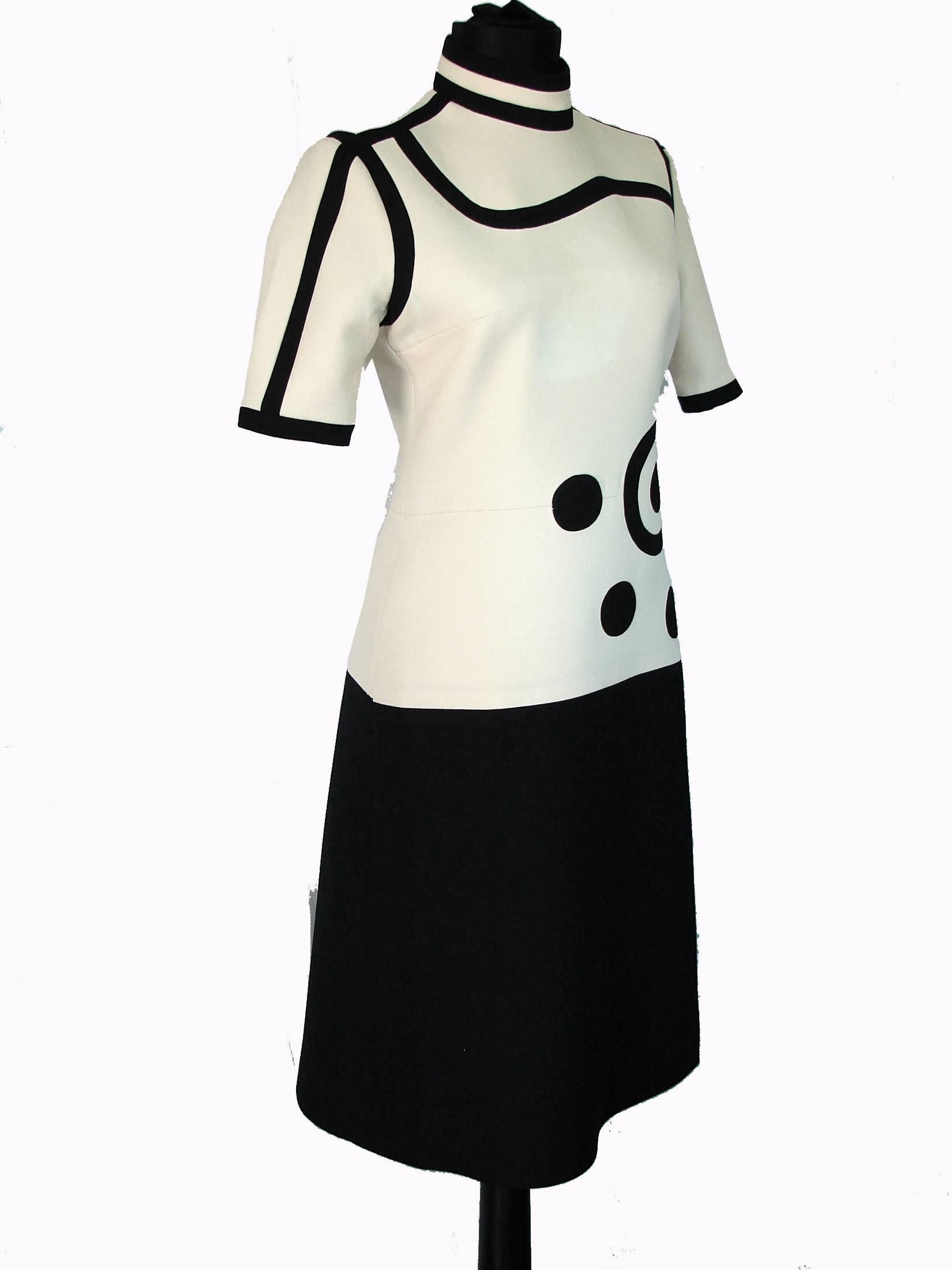 Here's a wonderful example of Louis Ferauds early work.  Made from what we believe is wool (no content tag), this dress bodice features black Op Art circles against a cream background, and the skirt is solid black! Very mod, yet very chic! In