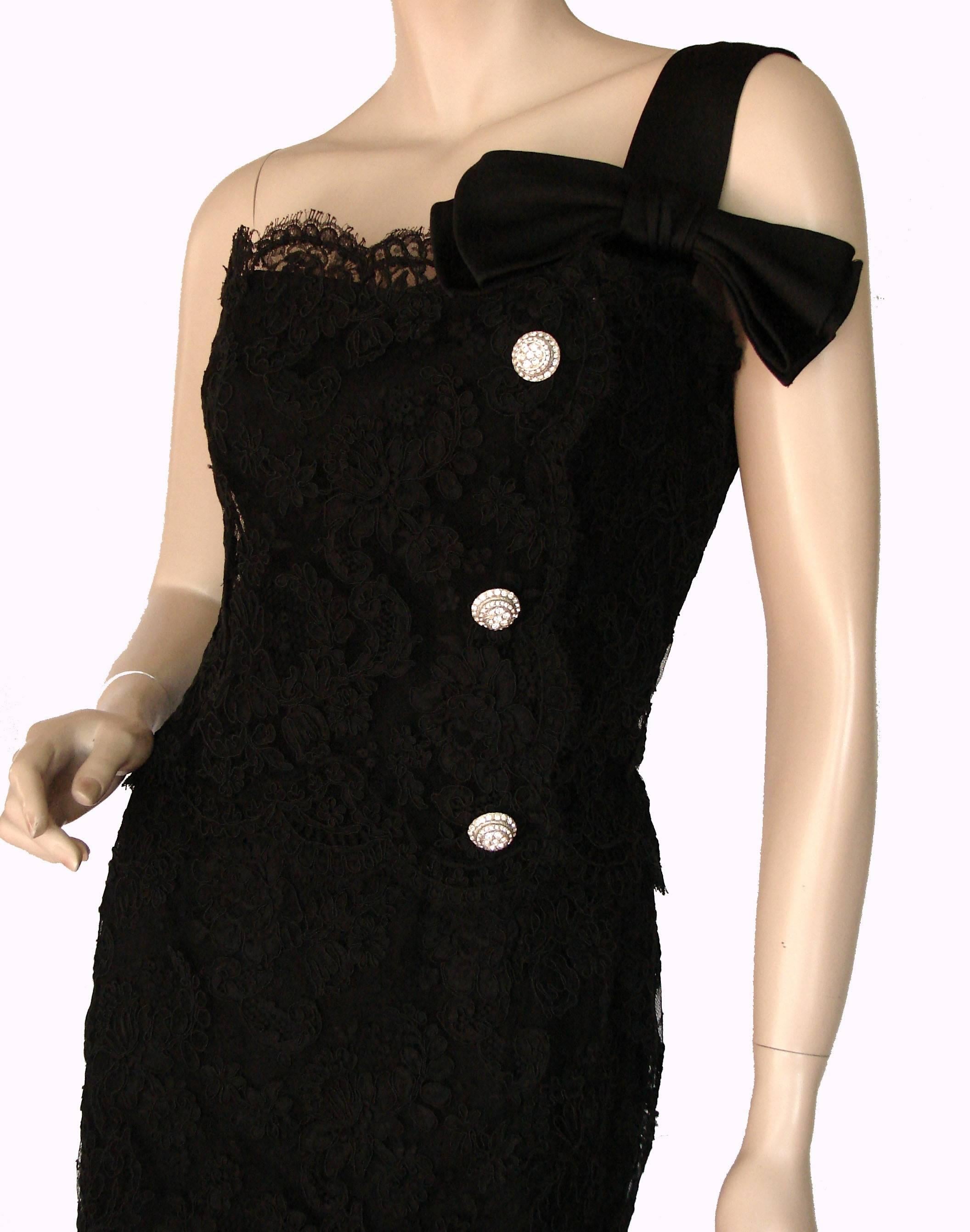 This black lace cocktail dress was made in the 1960s by Harvey Berin, known for his copies of Parisian designs and a favorite of Pat Nixon and other First Ladies.  Sheath-style with a wiggle skirt and fully-lined in black satin, this fabulous lace