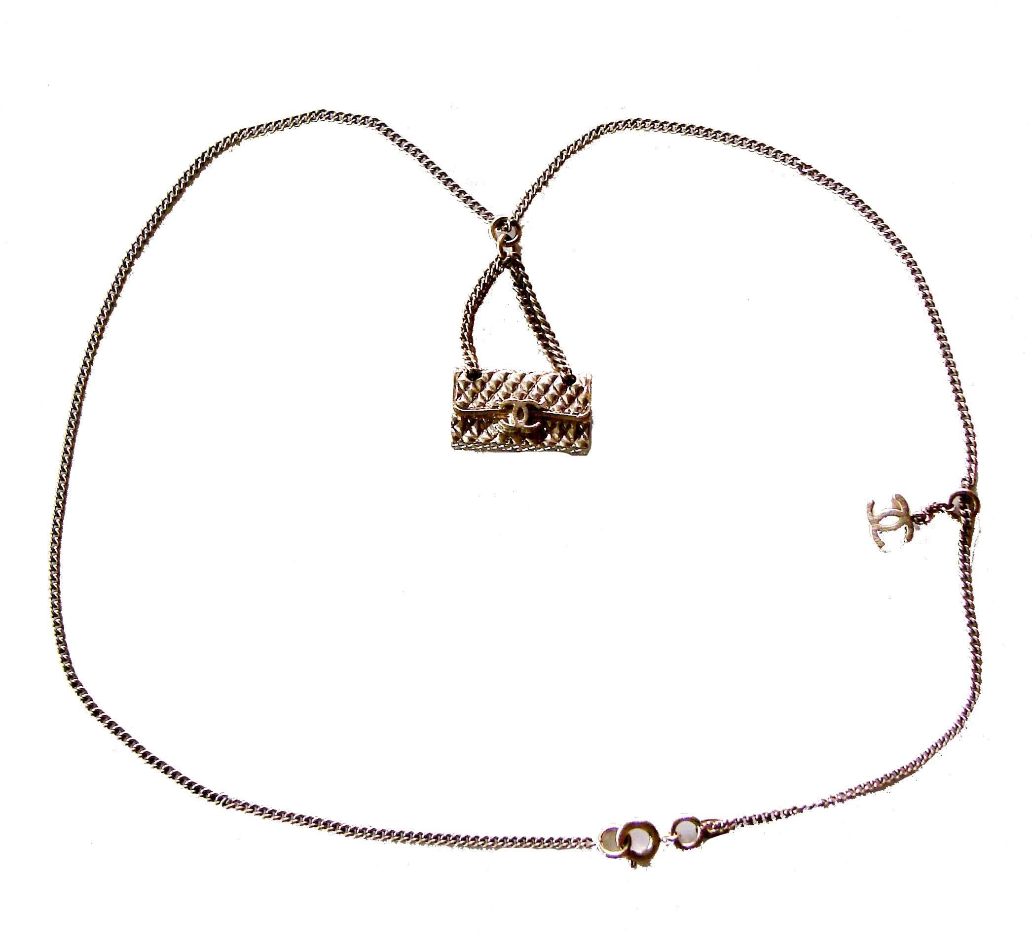 This necklace is so pretty! From Chanel's 2005 collection, it features a miniature charm of their signature 2.55 quilted bag that's attached with two dainty chains, and a separate tiny brushed metal CC charm! The gold metal is a pale yellow (with