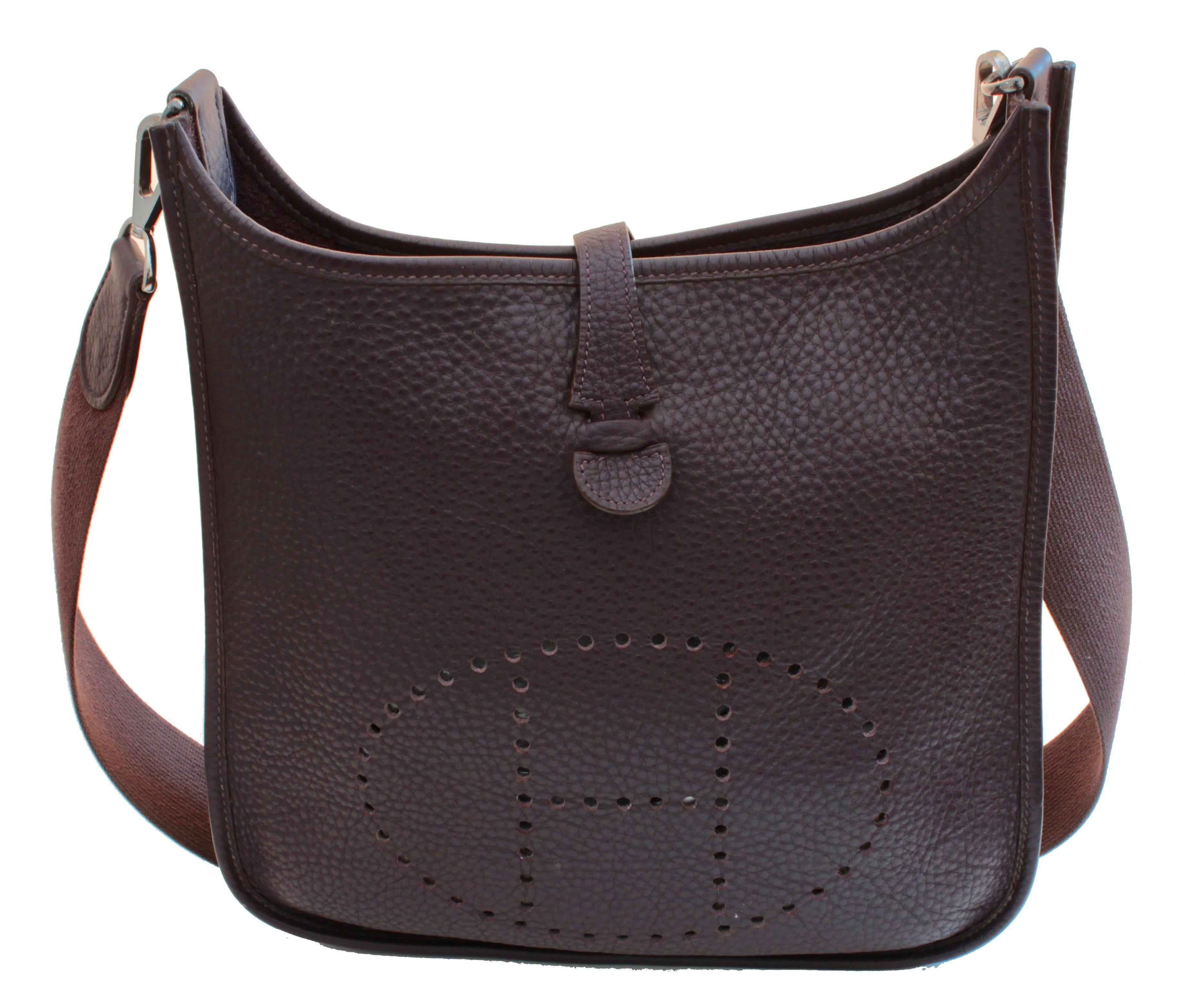 This incredible Evelyne I PM bag is made from their resilient Veau Taurillon Clemence leather in Raisin, which is a deep, almost eggplant colored shade.  The interior features one flat pocket and is unlined.  In excellent condition overall, we note