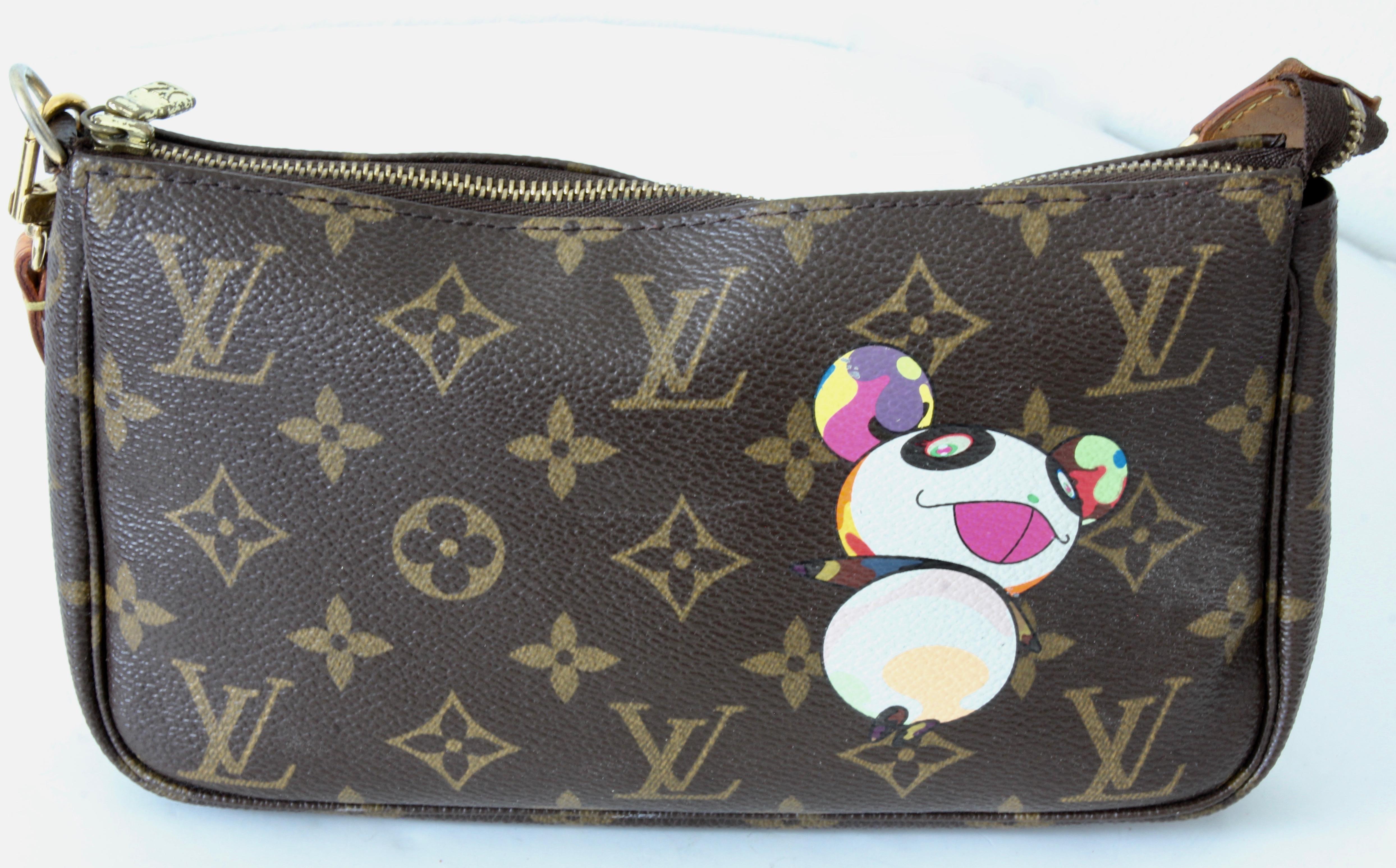 This chic cosmetics case is crafted of Louis Vuitton monogram on toile canvas with artist Takashi Murakami designed panda print on front and rear. The pochette features a vachetta cowhide leather wrist strap with a brass D-ring end to attach to any