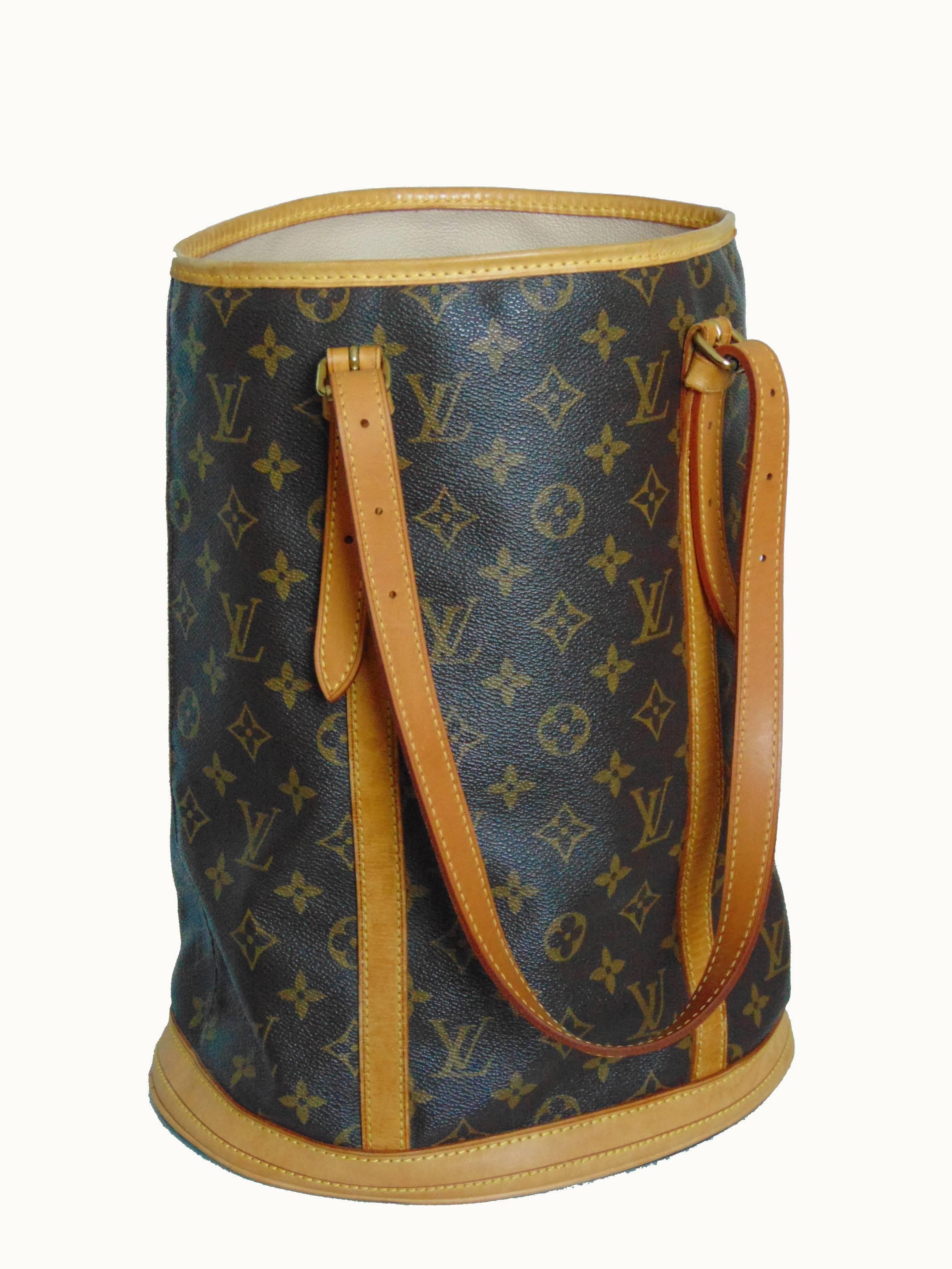 This fabulous bag was made by Louis Vuitton in 2005 and is no longer in production.  Made from their signature monogram canvas, this is the bucket bag GM, the largest size produced in this style.  It's trimmed in vachetta leather, lined in cream