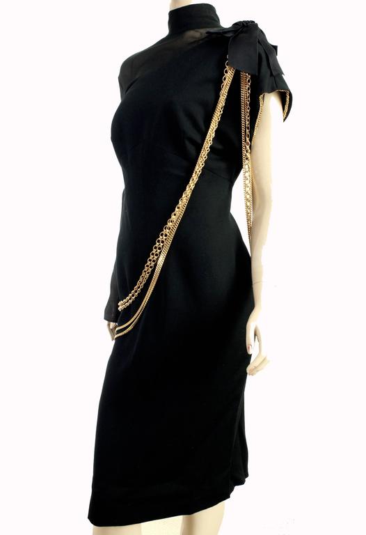 black chanel dress with gold chains