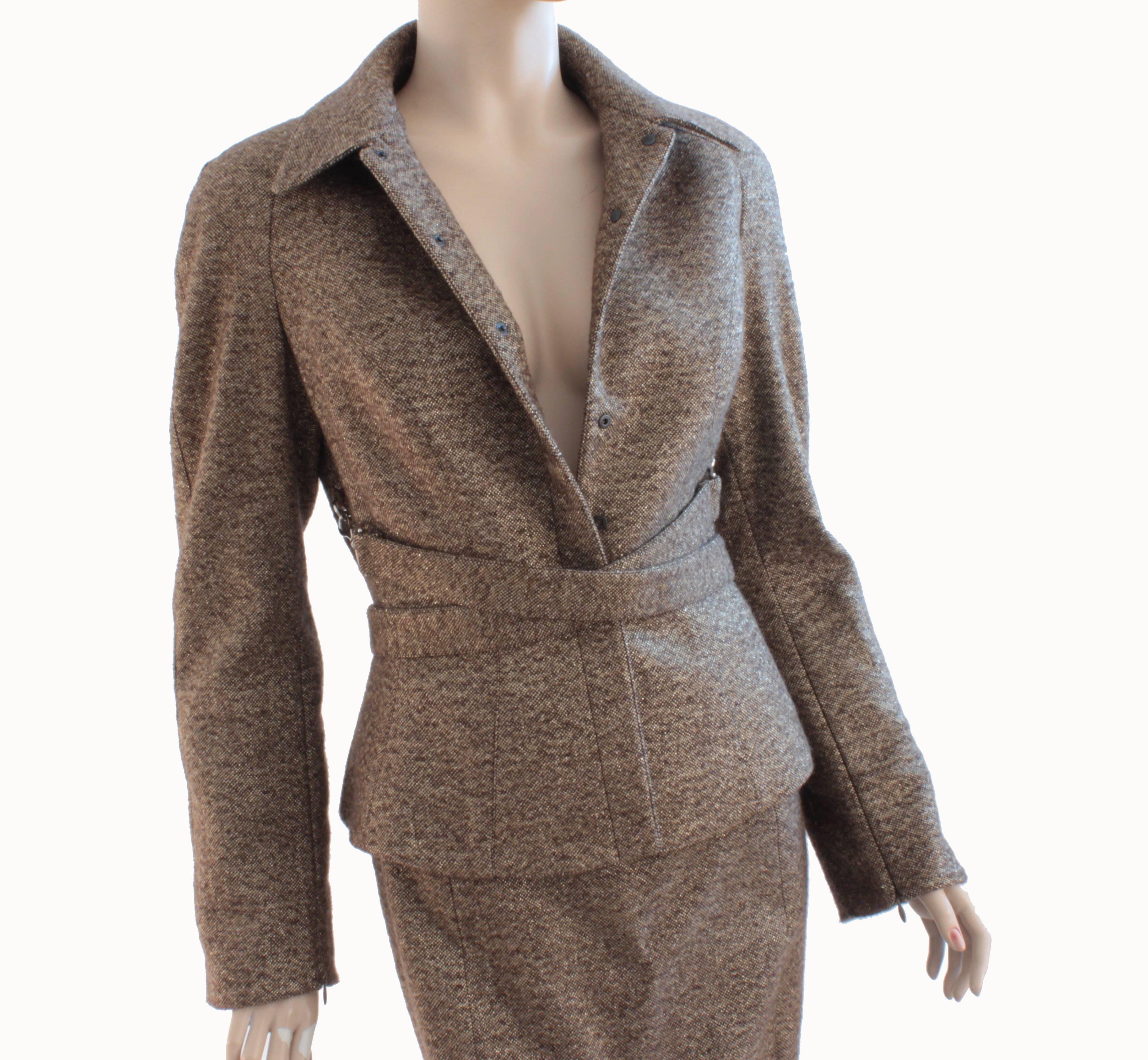 This jacket and skirt suit is from Thierry Mugler, most likely made in 2011, after the house was renamed MUGLER.  Made from a cream and tan tweed wool, it features flecks of gold lurex thread throughout.  The jacket has small dog leash clasps at