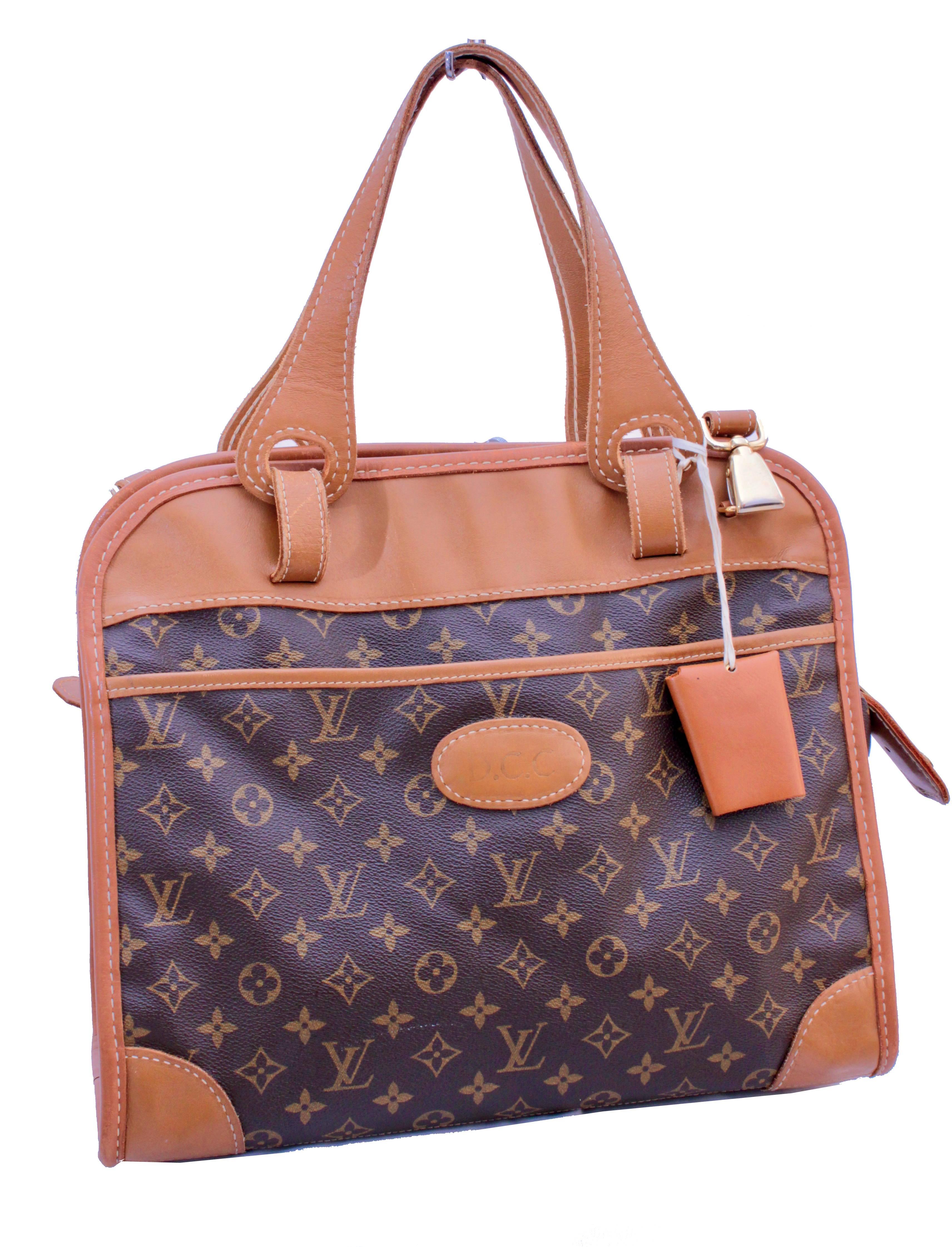 This incredibly rare carry on bag was made by The French Company under special license by Louis Vuitton, most likely in the early 1980s.  Made from their signature monogram canvas, it features double handles, a removable and adjustable shoulder