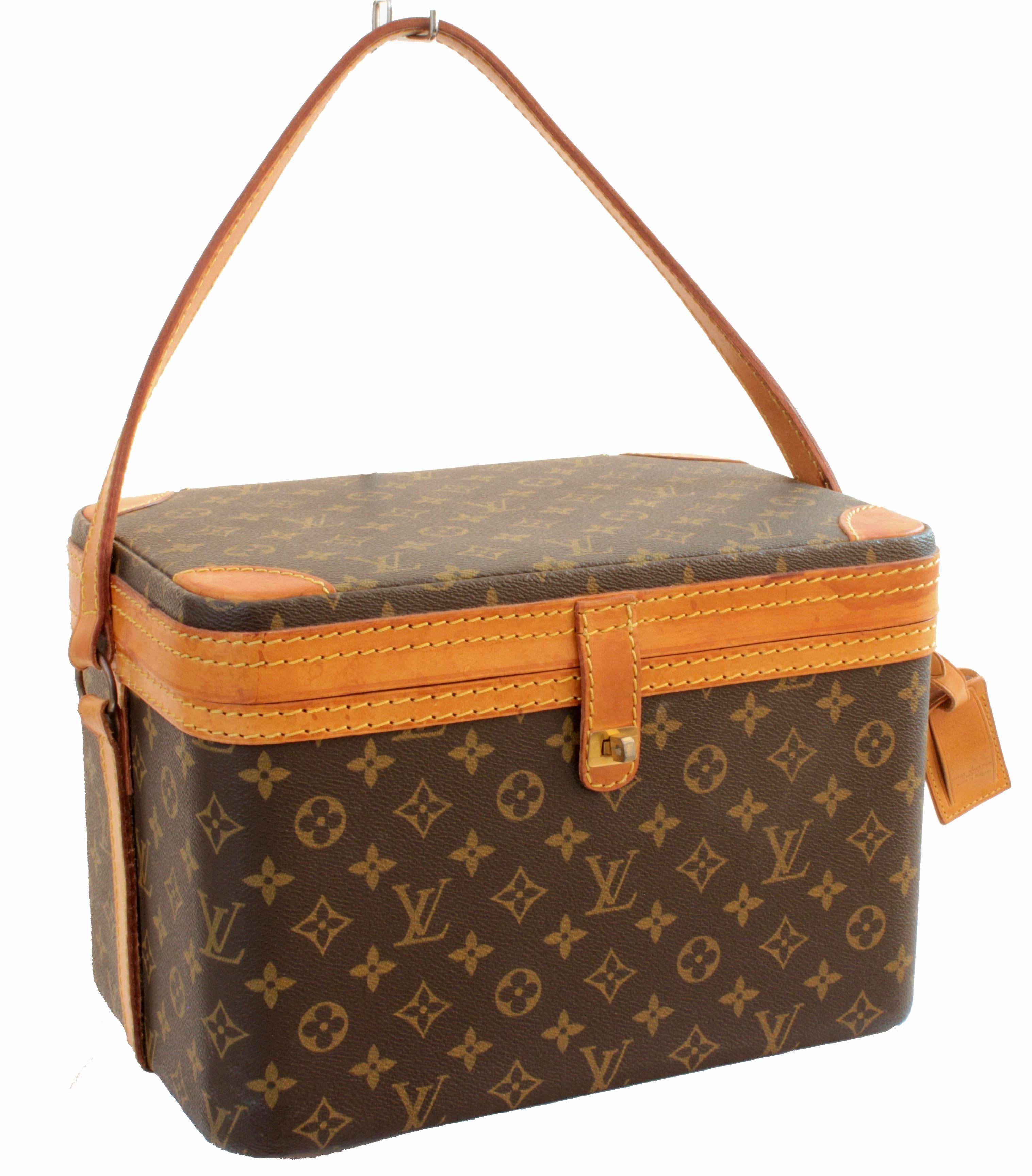 This fabulous and hard to find train case was made by Louis Vuitton in the early 1980s. Made from their signature monogram canvas, it's trimmed in vachetta leather and fastens with a gold metal turn lock. The interior is lined in cream fabric and it