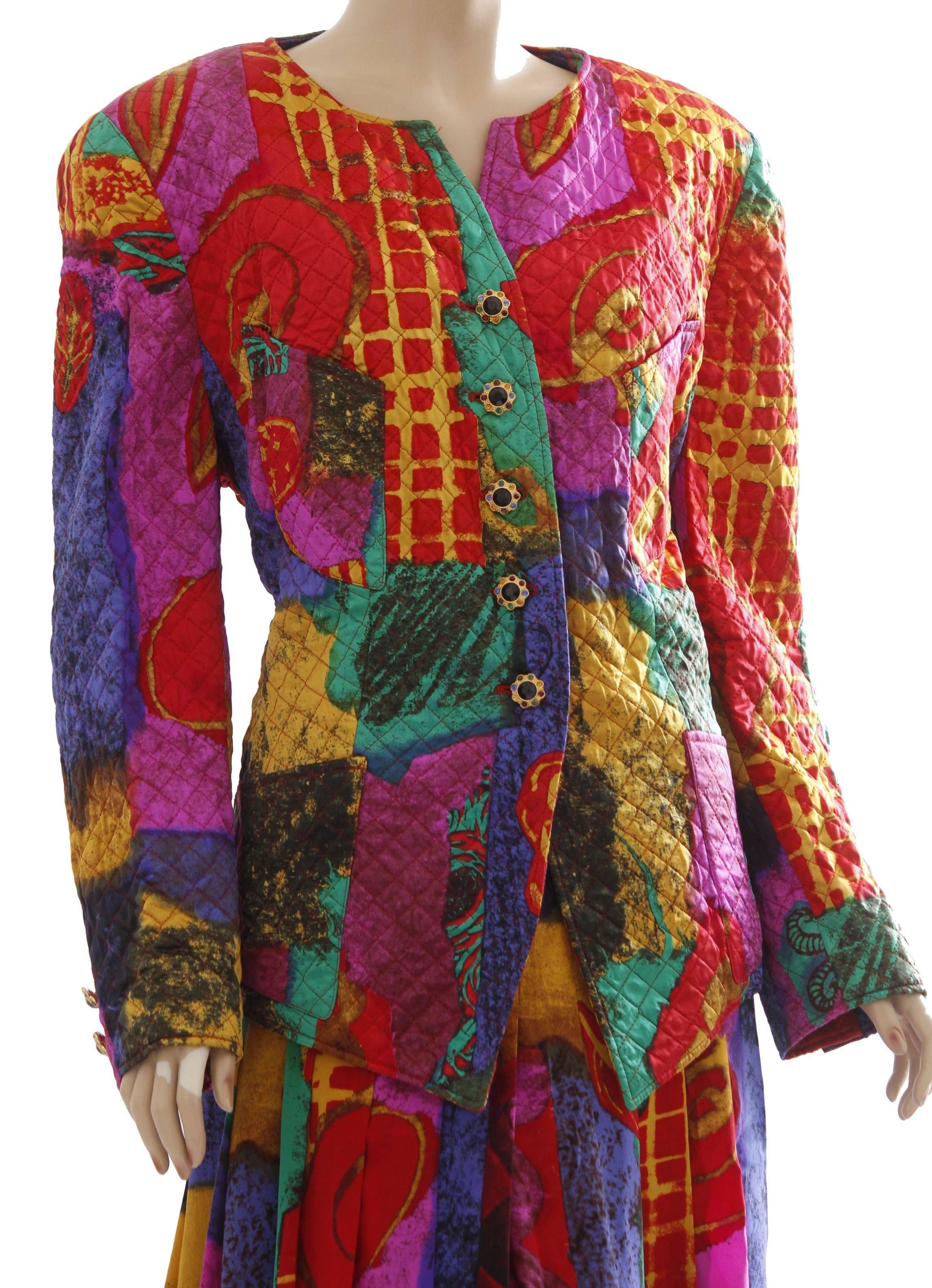 This colorful silk jacket and skirt ensemble was made by Louis Feraud, likely in the 1980s,  Made from a colorful silk print fabric, the jacket features textured quilting and four pockets, and the skirt has box pleats.  In excellent condition with