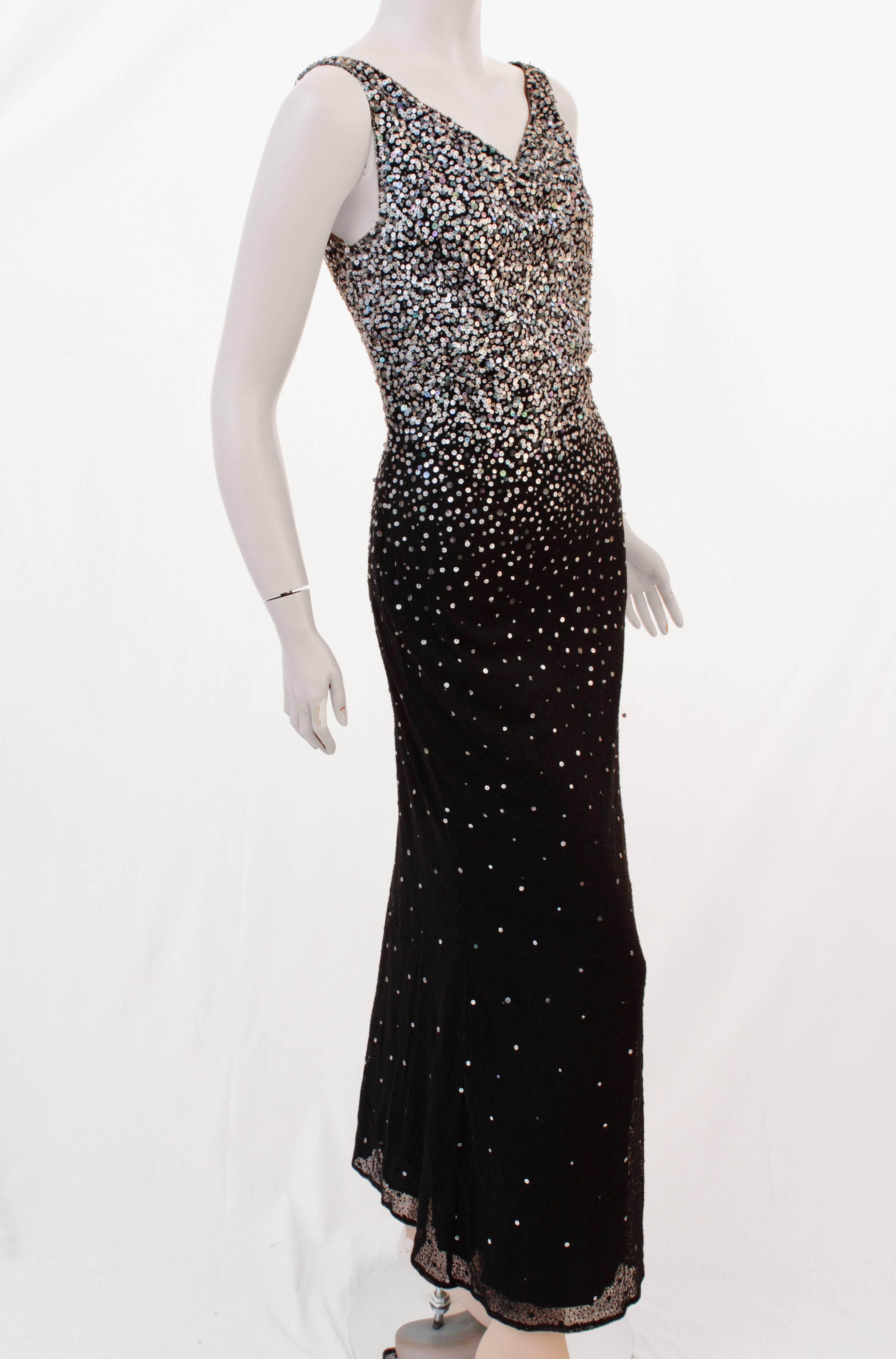 This fabulous form fitting evening gown was made by Naeem Khan and sold by luxury boutique Barbara Katz of Boca Raton, most likely in early 2000.  Made from black silk, this full-length gown features hundreds of sequins that shimmer and throw off