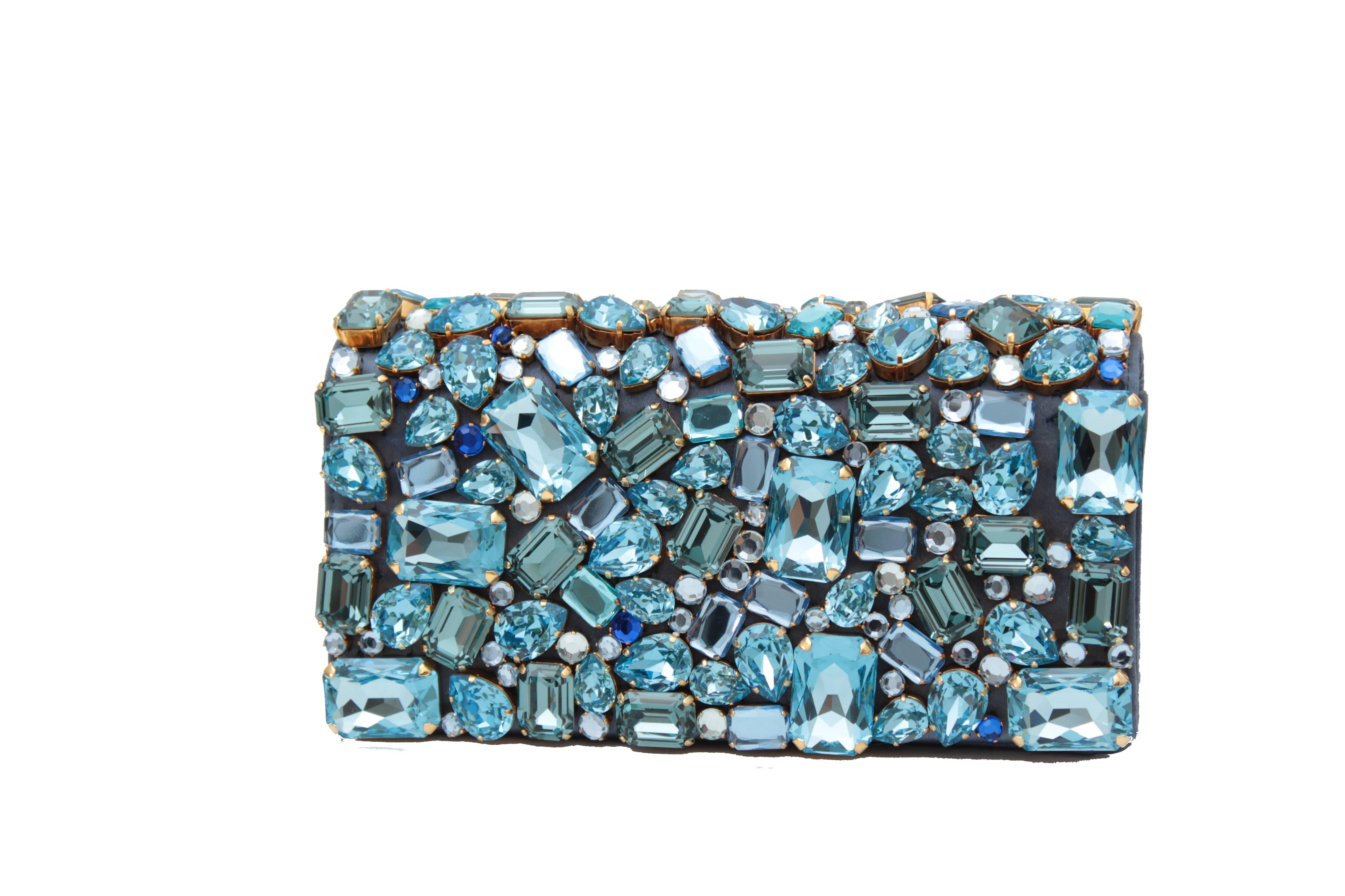 This embellished clutch was made by Prada and features tons of chunky crystals in shades of blue.  Fastens with magnetic clasp on flap and features a small flat open pocket inside.  Comes with its original box.  In excellent preowned condition with