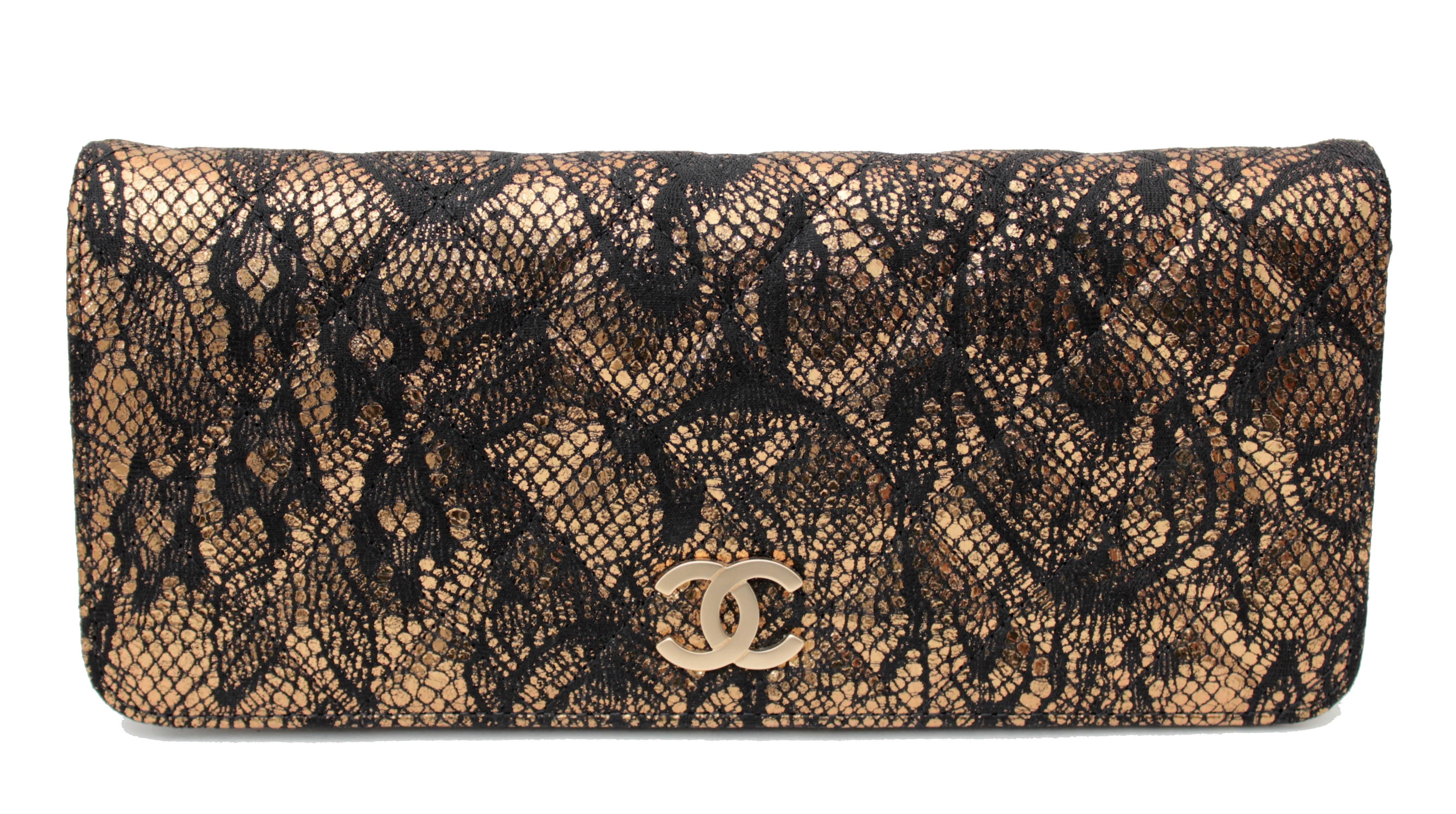 This fabulous metallic leather clutch was made by Chanel between 2010 and 2011, and features a shimmering gold matelasse covered in black lace.  It's lined in black lambskin leather and features one flat pocket two open pockets and one zip