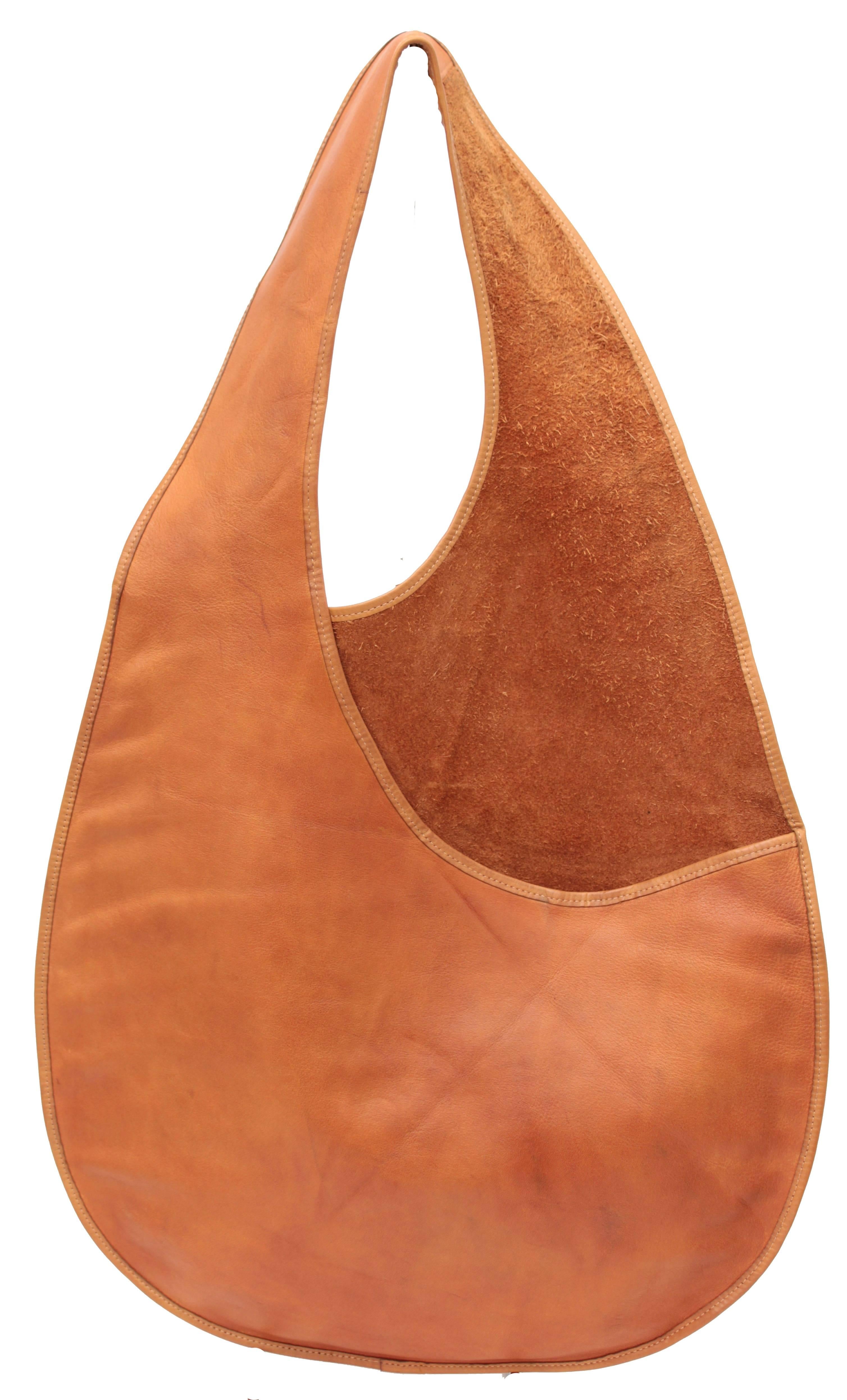 This mod sling bag was designed by Bonnie Cashin during her time at Coach Leatherware circa mid 1960s. According to an article in ELLE magazine from 2011, FIT has one of these bags in their museum collection, and I believe another lives within the