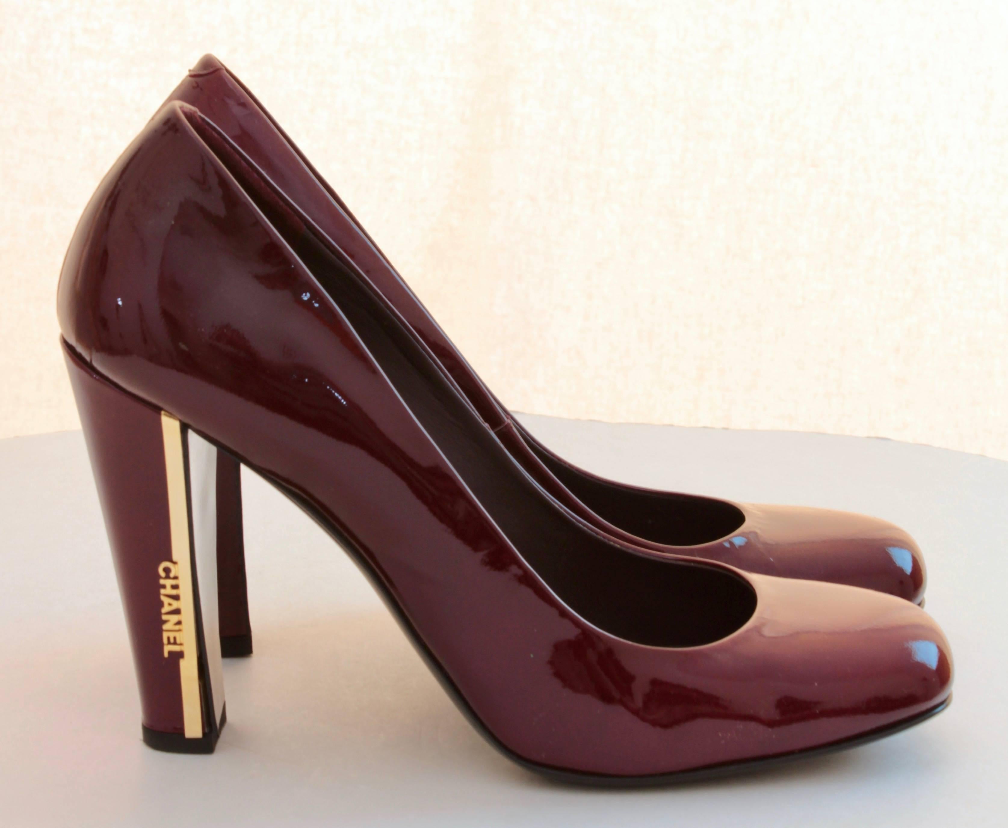 Here's a pair of patent leather heels from Chanel, made back in 2008.  Made from a maroon patent, they feature the Chanel logo on the outside of each block heel.  In very good condition for their age, with only minimal signs of prior wear.  Size 39,