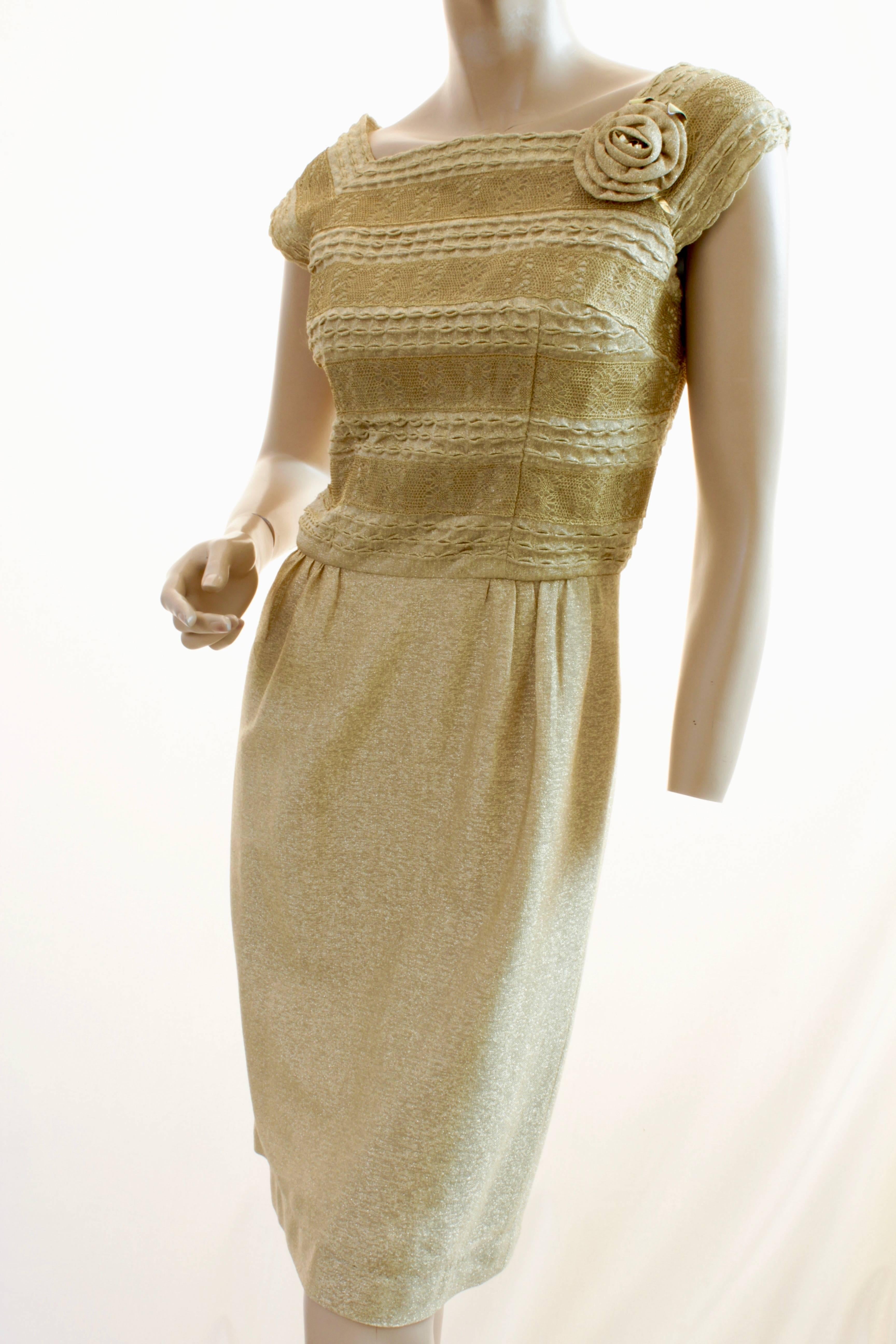Here's a pretty cocktail dress from Carlye for I.Magnin.  Made from a gold lurex fabric, it features a gold macrame overlay at the bodice with a large rosette at the wearer's left shoulder.  Fastens in back with a metal zipper.  In very good