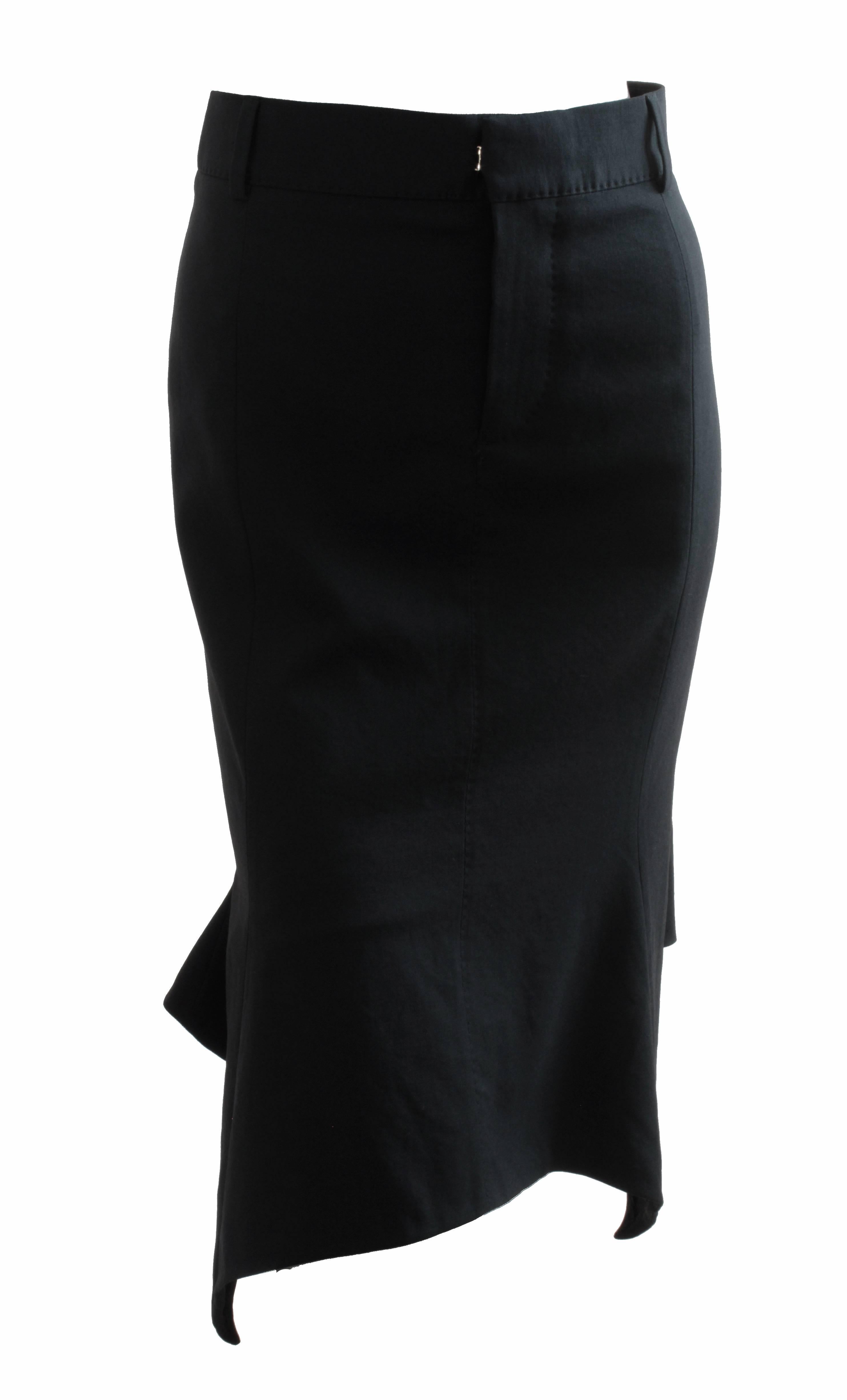 This fabulous dropped hem skirt was made by Tom Ford and retailed for $1295. Made from a light weight wool, it's fully-lined in black silk and fastens in front with a button, flat hook & eye closure and zipper.  We love the asymmetric hem that