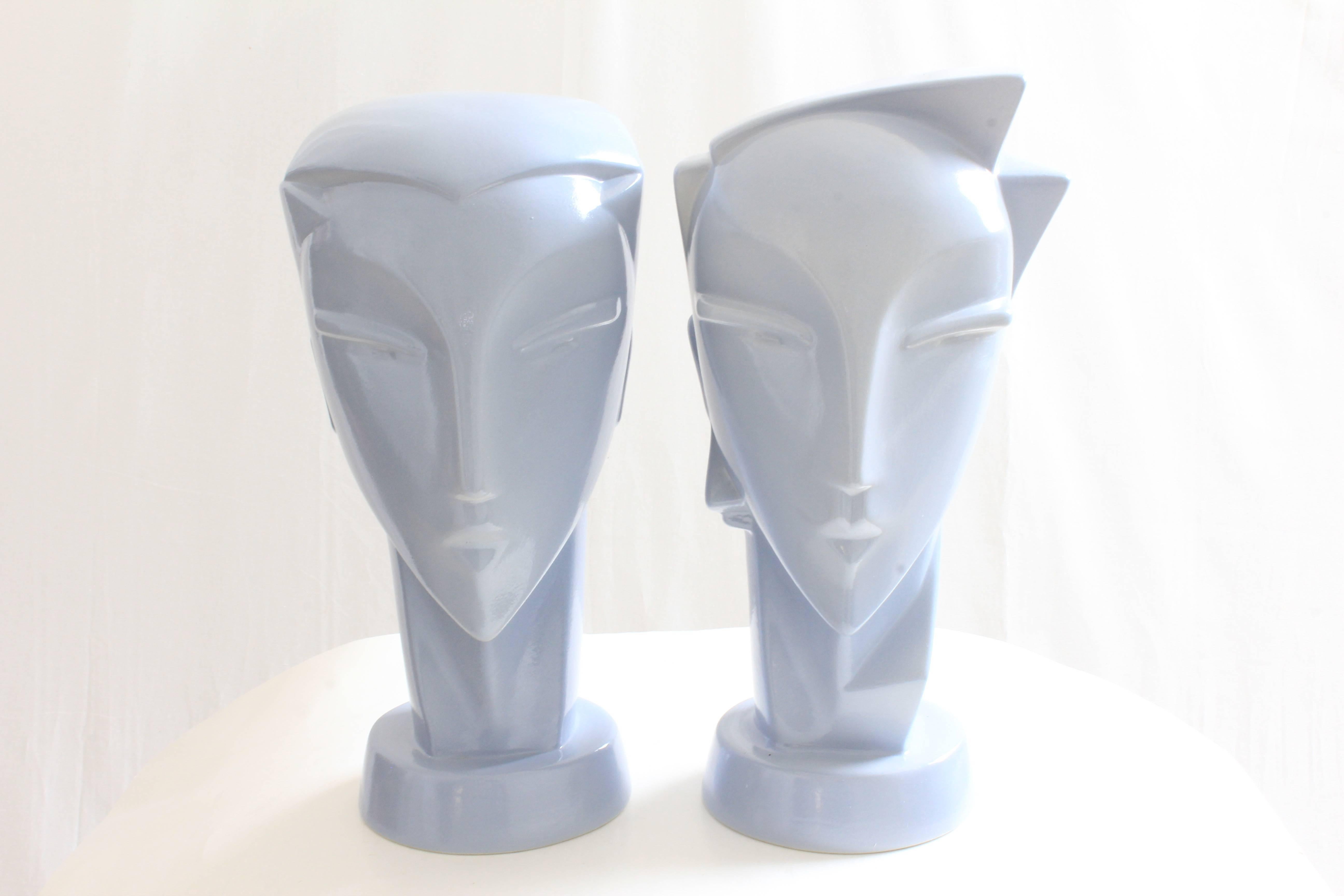 Here's a pair of highly stylized ceramic head sculptures, one male and one female, most likely made in the 1980s.  Made from a lilac-hued blue glossy finish, they measure appx 14in H x 8in W (at the widest portion of the head). These pieces are very