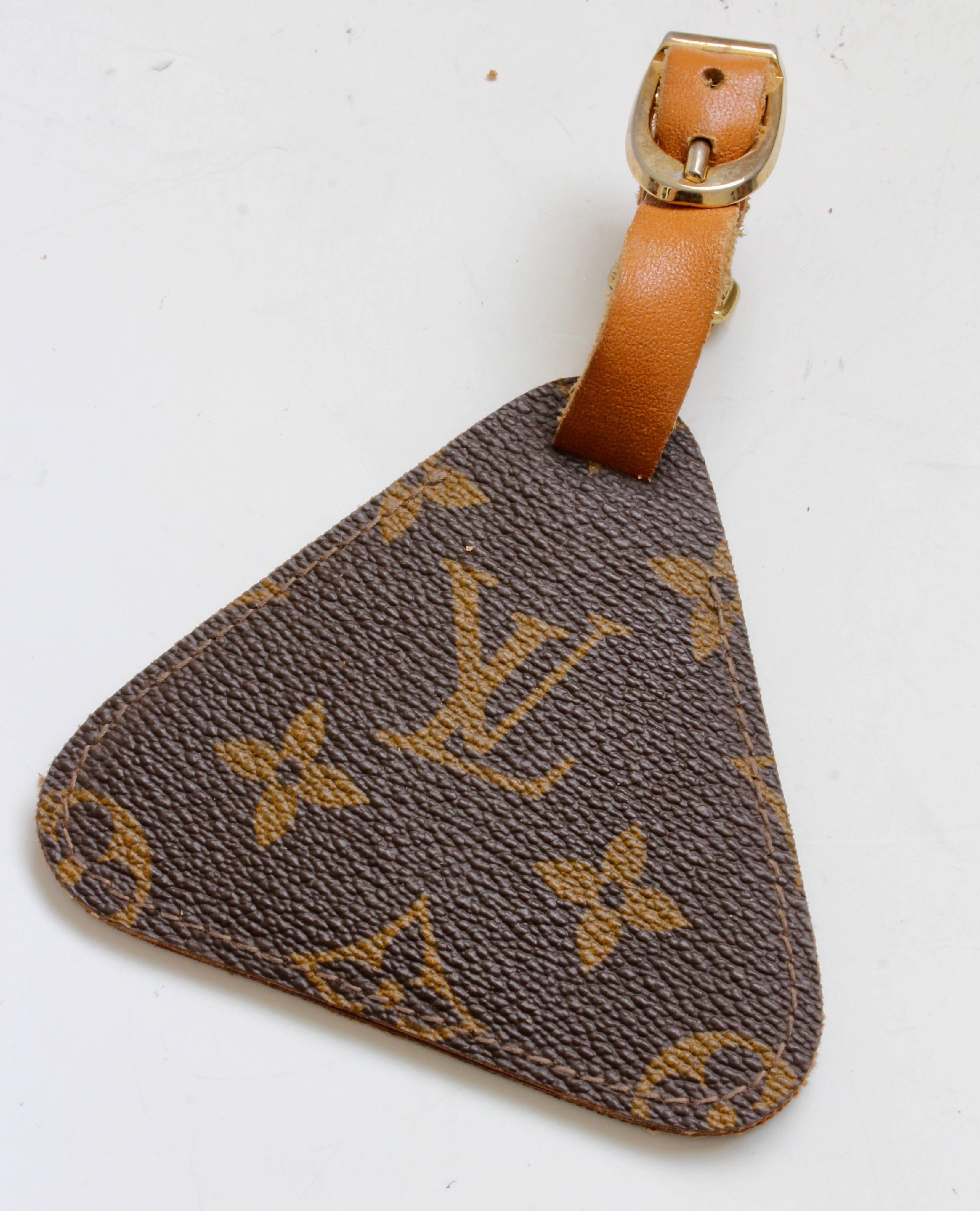 Here's a hard to find luggage tag made in the 1970s by The French Company under special license from Louis Vuitton.  Made from their signature monogram canvas, it features a coated leather interior with clear ID window and a leather buckle strap. 