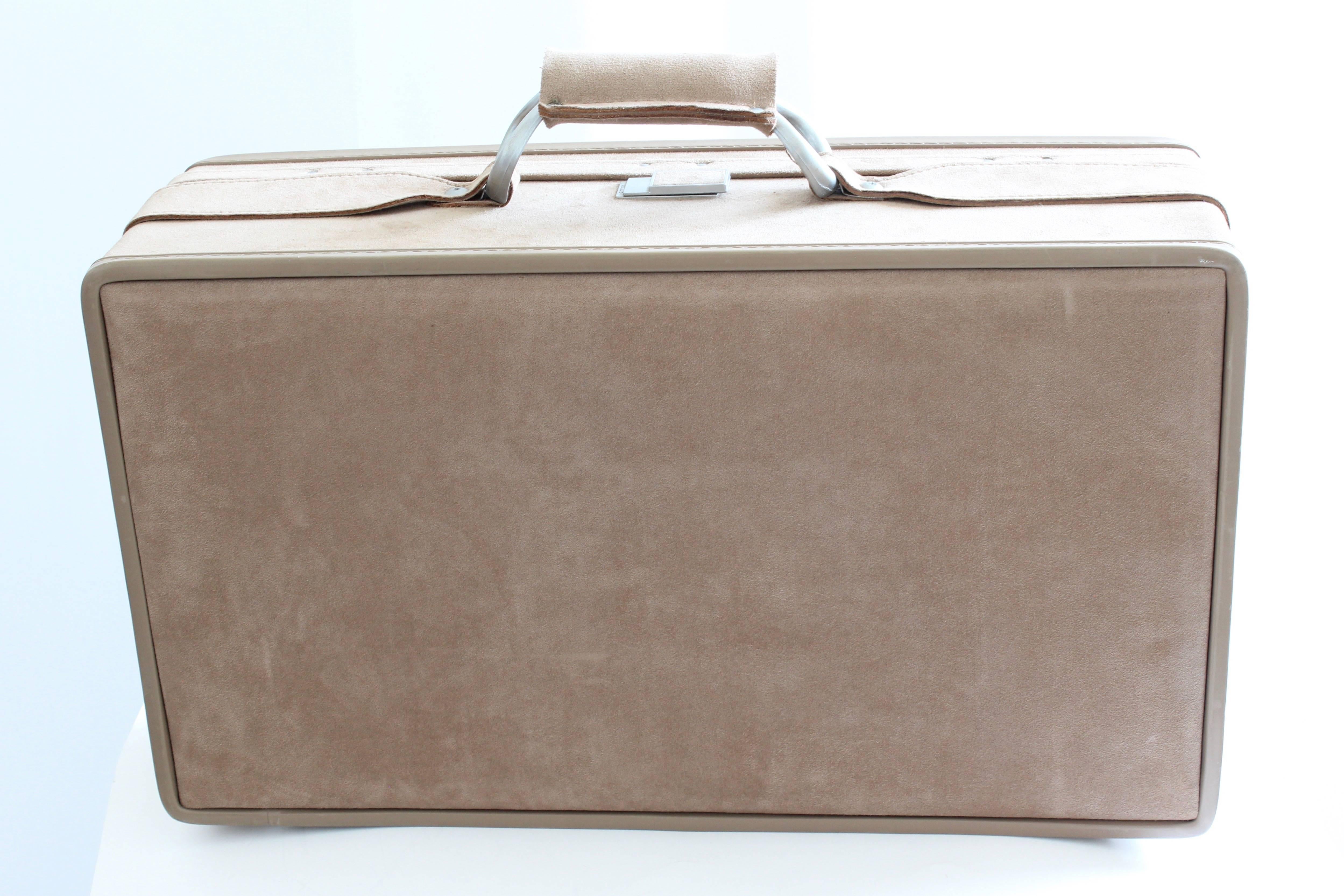 Here's a 21in belting suitcase from Hartmann, most likely made in the early 80s.  Made from taupe ultrasuede, this was part of a larger collection we recently acquired that was made by Hartmann for Halston (see images 11 & 12, where we show all bags