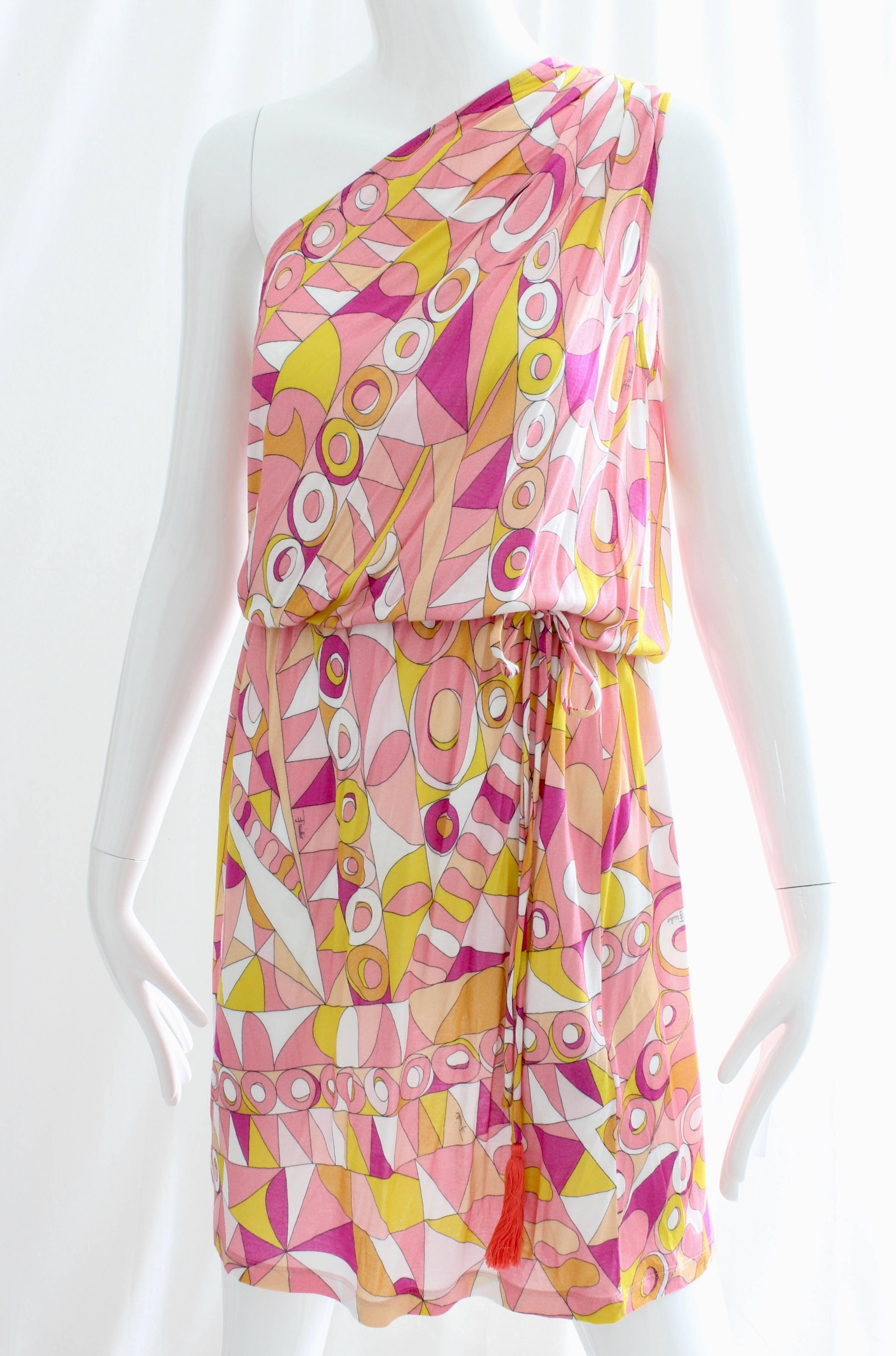 This chic little one shoulder dress or beach romper was made by Emilio Pucci.  Made from viscose, it features an abstract print, an attached drawstring with tassels at the waist and is unlined.  Perfect for your summer jaunts and adventures! New