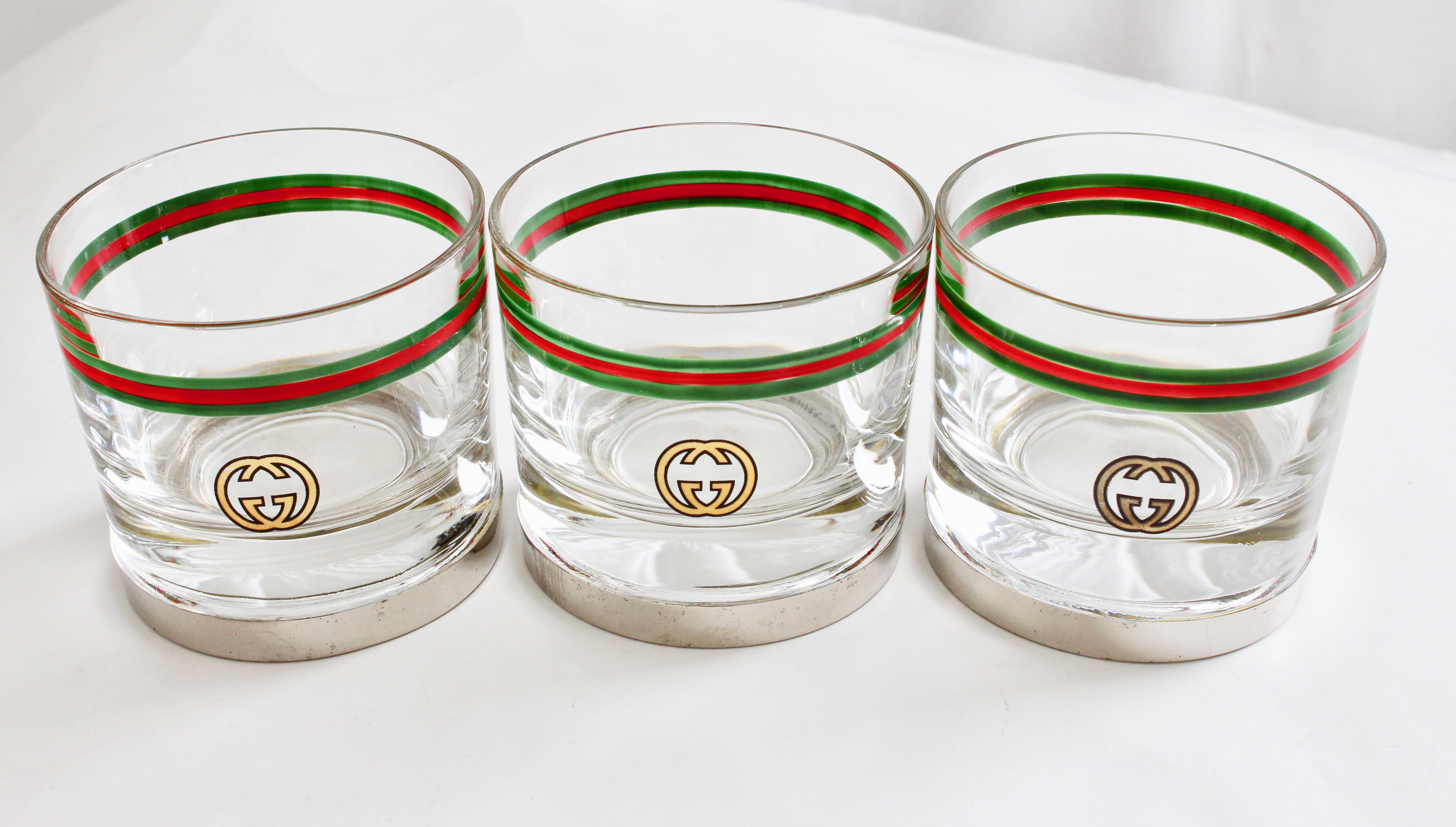 This set of 3 cocktail glasses was made by Gucci, most likely in the late 70s.  Extremely rare and perfect for entertaining, they feature Gucci's GG logo in gold with red and green webbing and silver plated bases.  Each cup is stamped GUCCI ITALY on