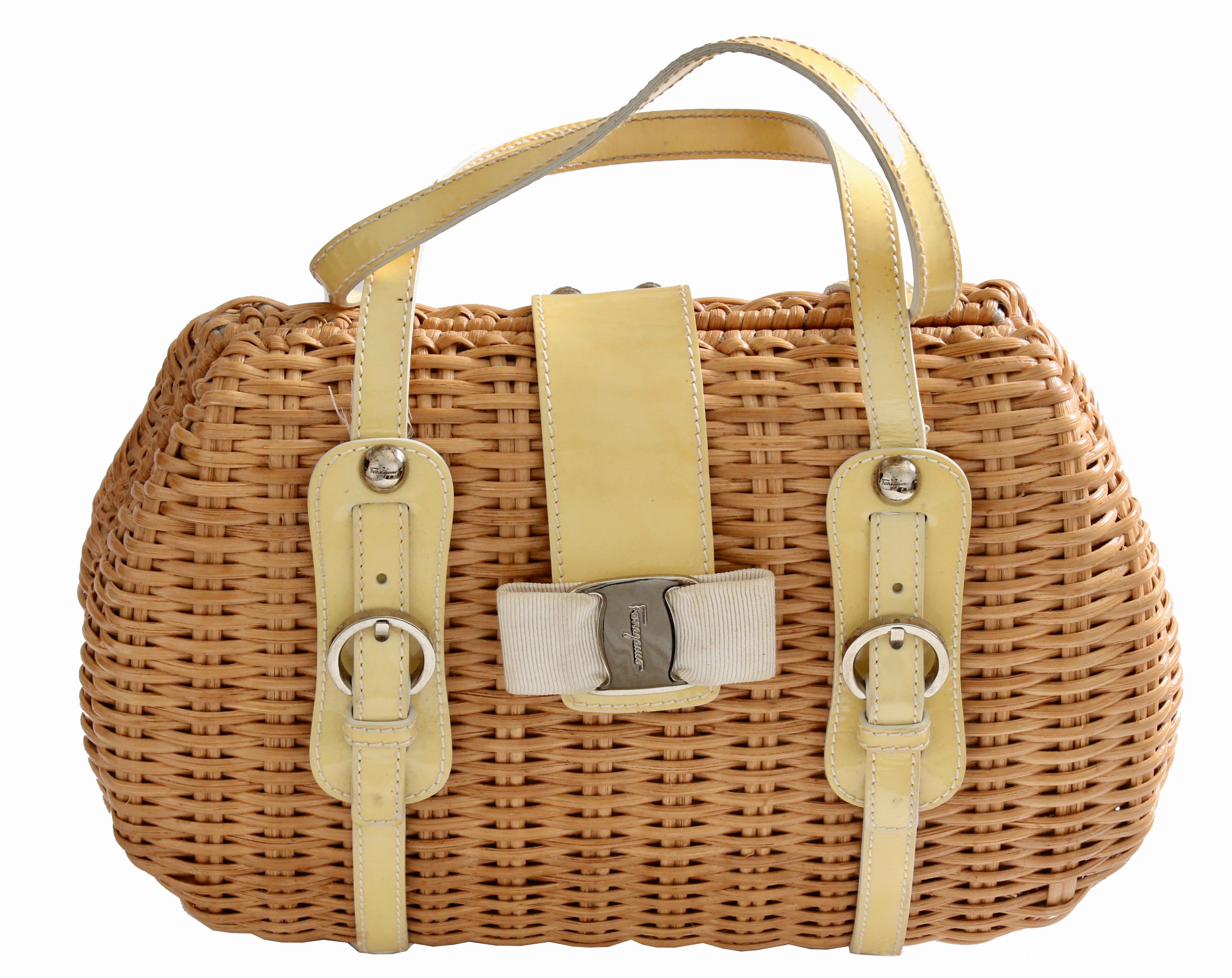 Here's a natural wicker Salvatore Ferragamo handle bag with silver-tone hardware, yellow patent leather trim with white contrast stitching and buckle accents at front. It features protective feet at the base, a pale yellow satin interior lining with