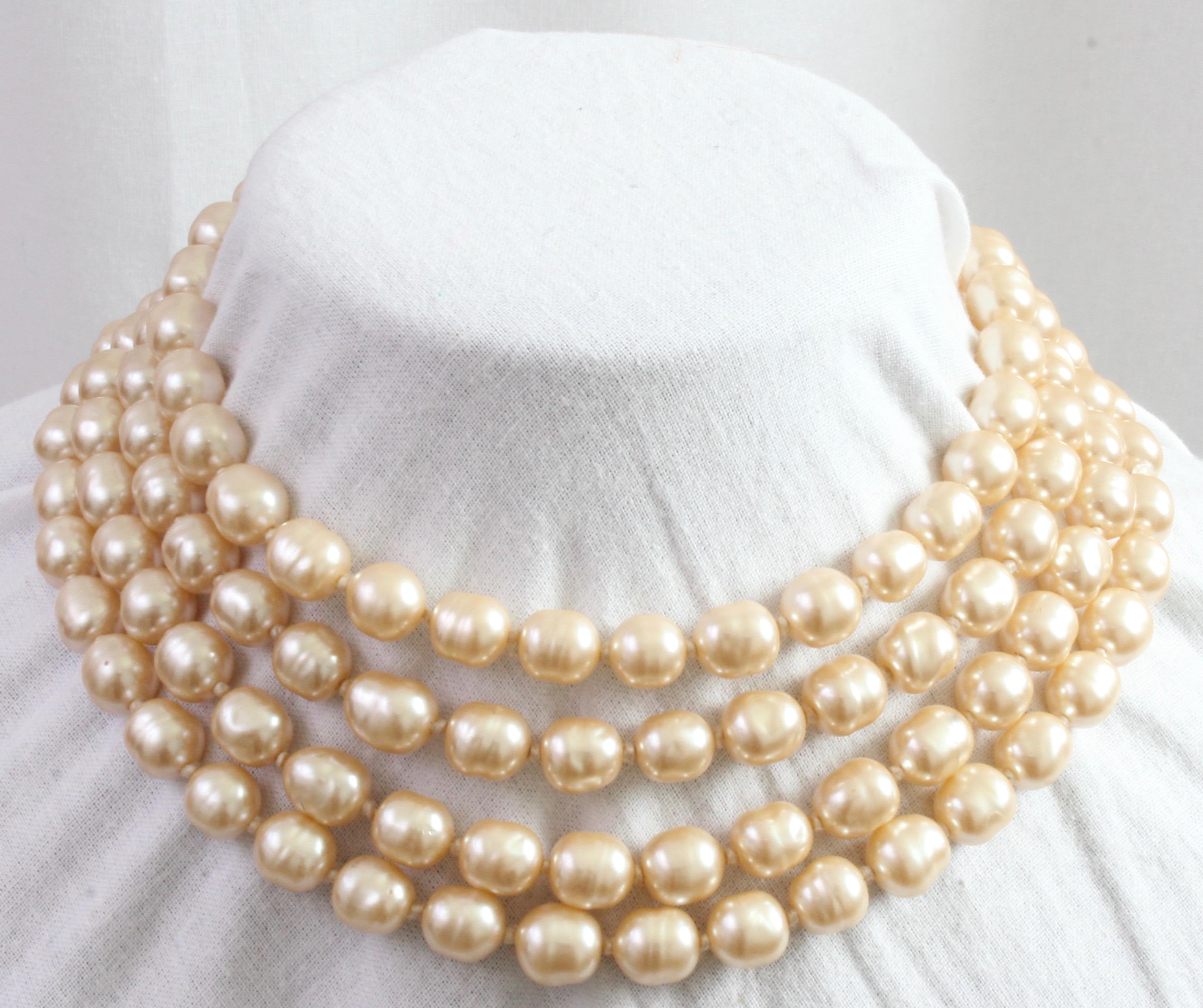 Here's an amazing single pearl strand infinity or opera length necklace from CHANEL that measures 65in long, enabling doubling or even tripling on the neck, depending upon neck size.  The color is a gold hued cream, which makes for a lovely contrast