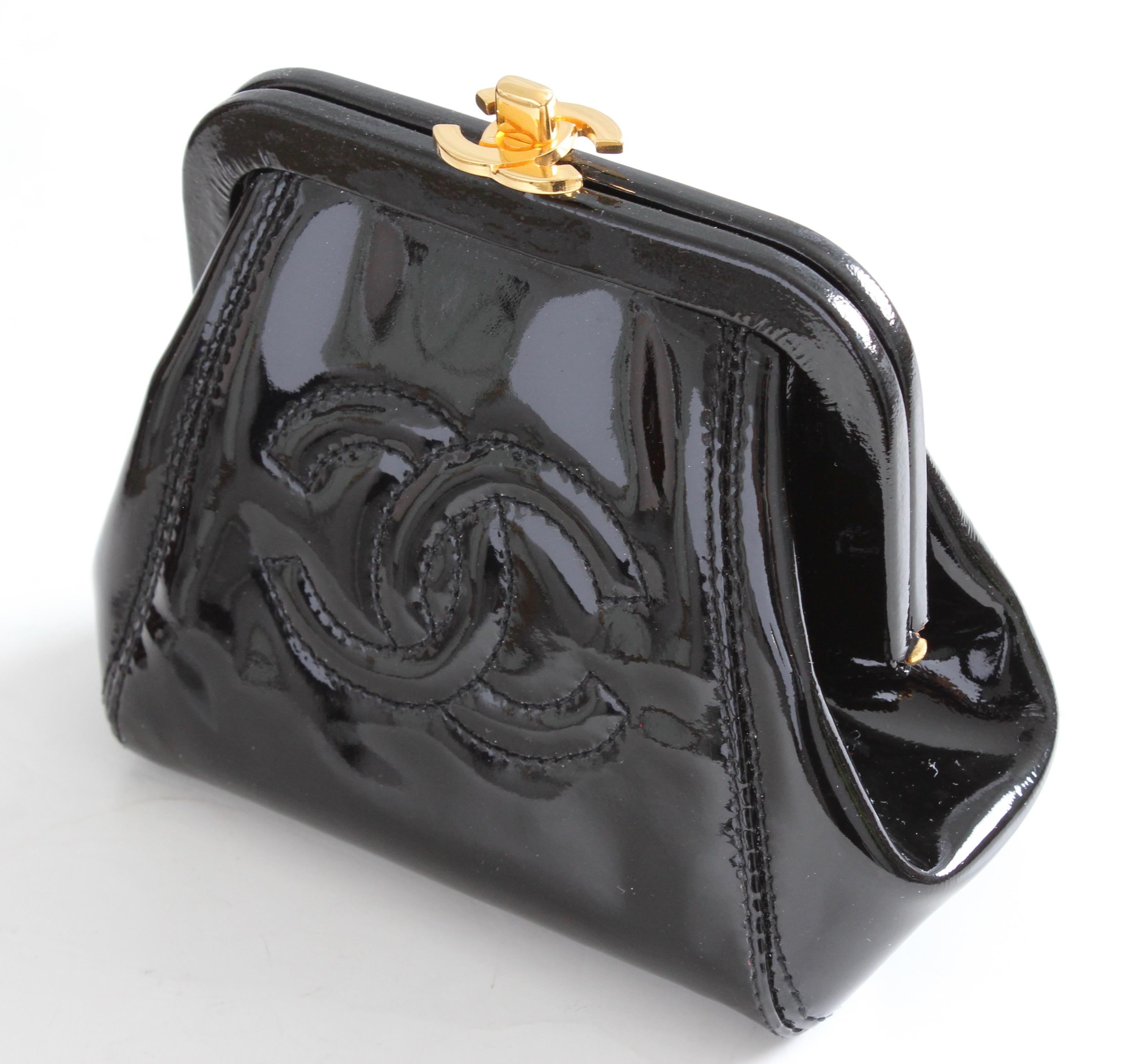 Here's a pretty little patent leather coin purse or small clutch from Chanel, made in 1996.  Made from black patent leather, it features a CC logo in front and a gold CC logo fastener on top.  The interior is lined in grosgrain with one small