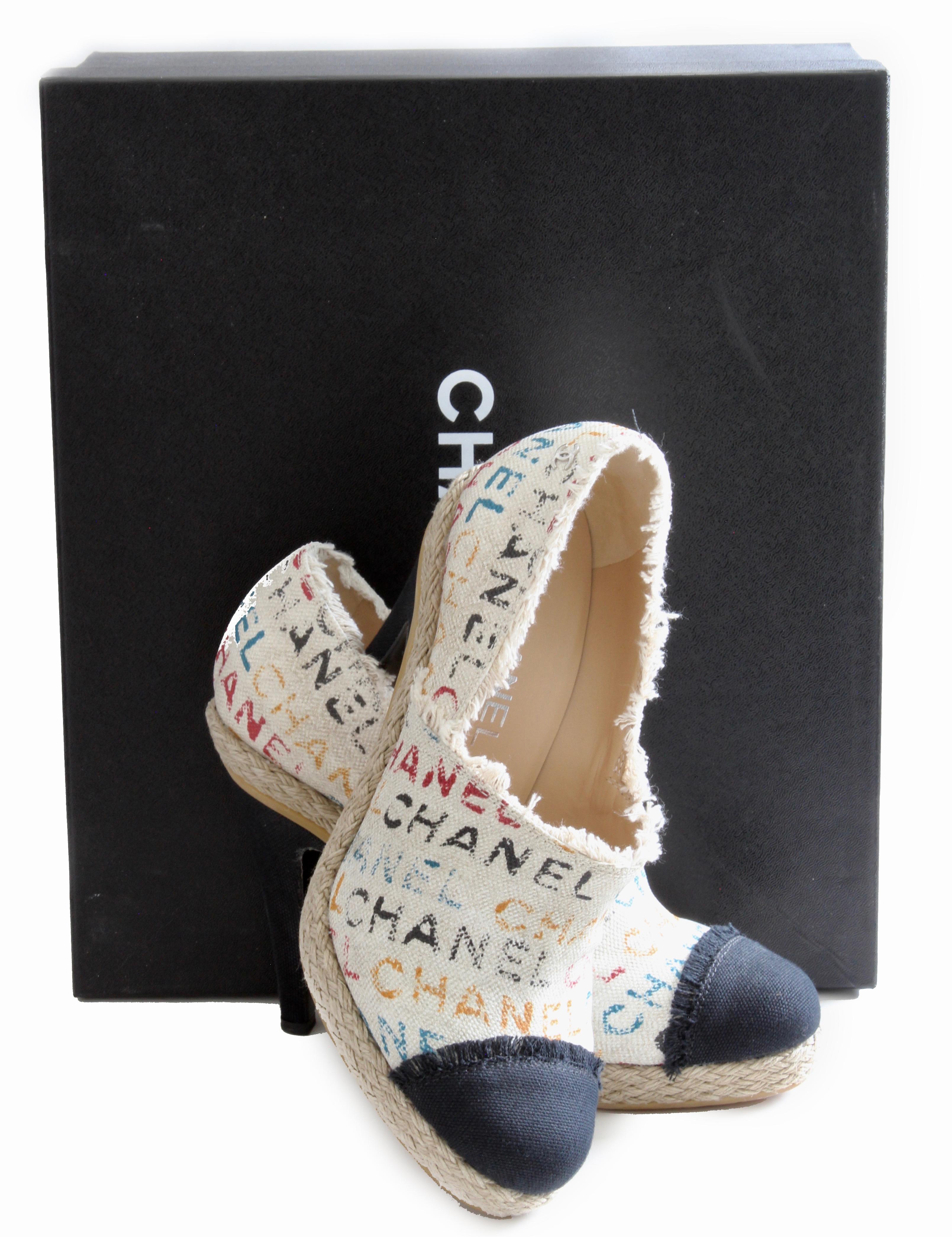 Here's a pair of Limited Edition Chanel Graffiti Toile Espadrille Heels from their Spring 2014 collection.  Made from a fringed multicolor Chanel logo-stamped canvas, they feature round toes and 4.7in heels.  Slip-on style with a small silver CC