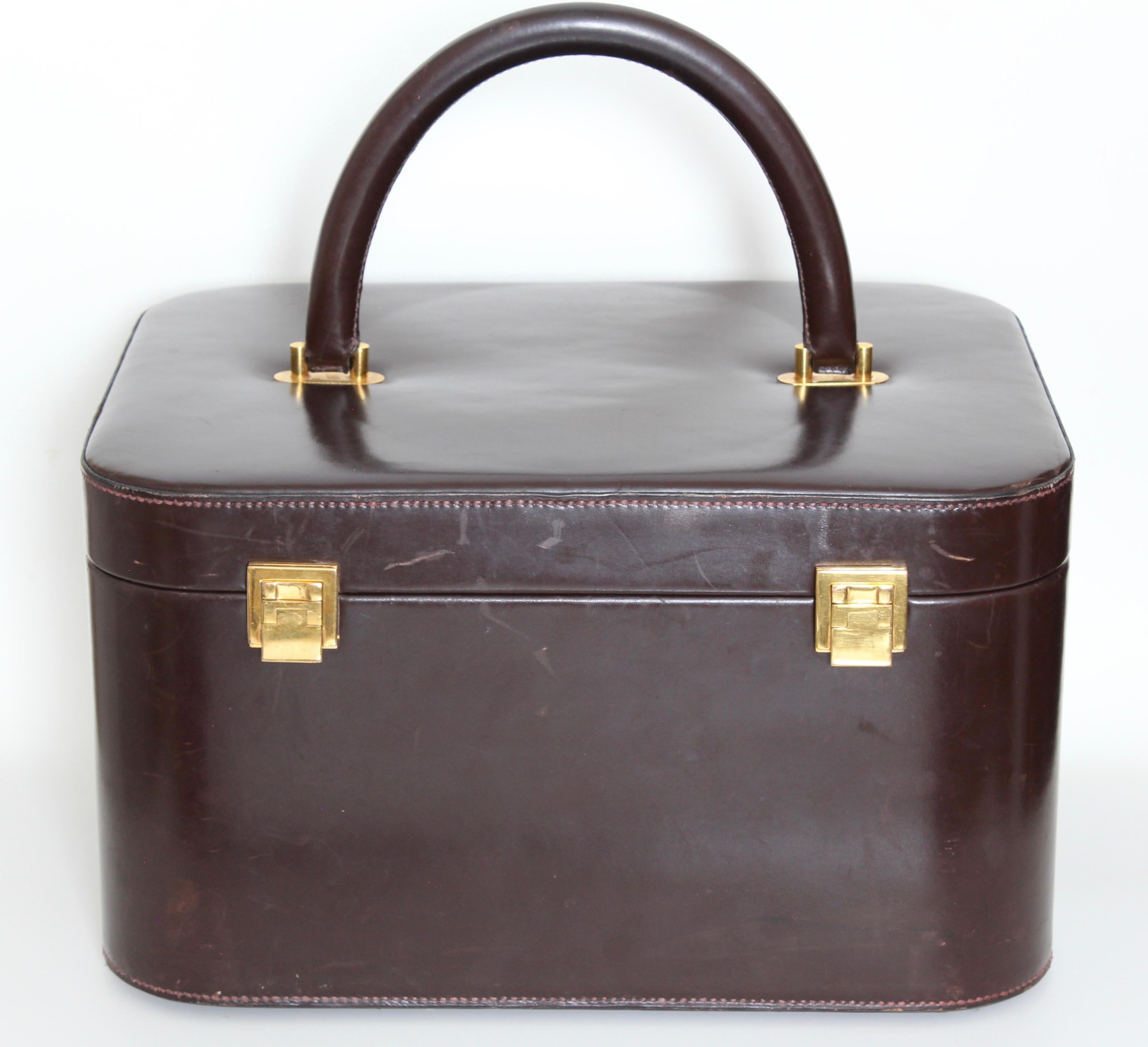Here's an extremely rare style travel bag that doesn't come up for sale very often. From HERMES PARIS, this extremely rare train case or vanity was likely made as a special order in the 1950s.  Made from brown box leather, it features a leather