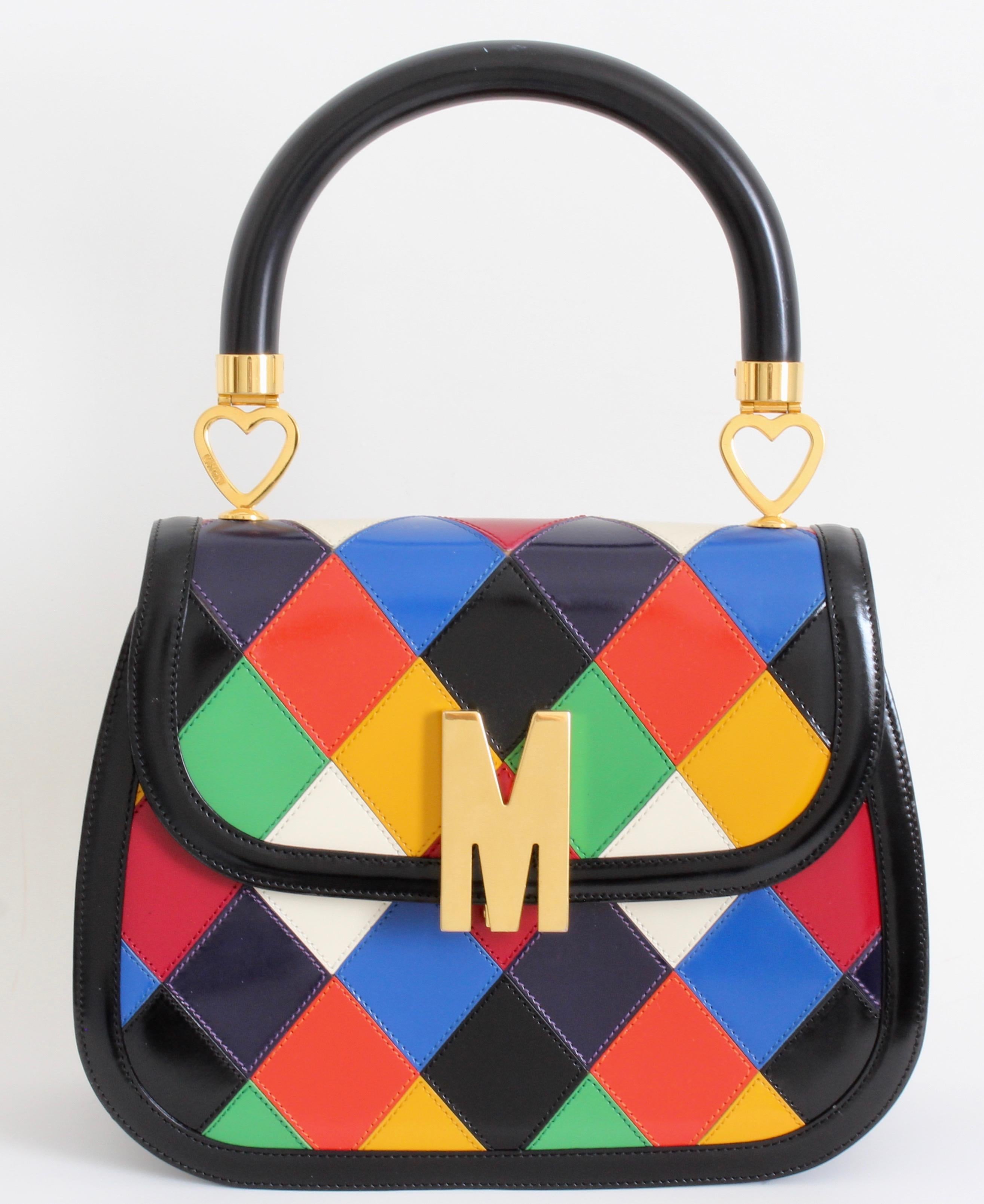 The colors on this vintage 80s Moschino bag are so amazing! Manufactured by Redwall Italy under license by Moschino, this incredibly rare bag is made from multicolored diamond patent leather patches with gold metal hardware. The top handle has small