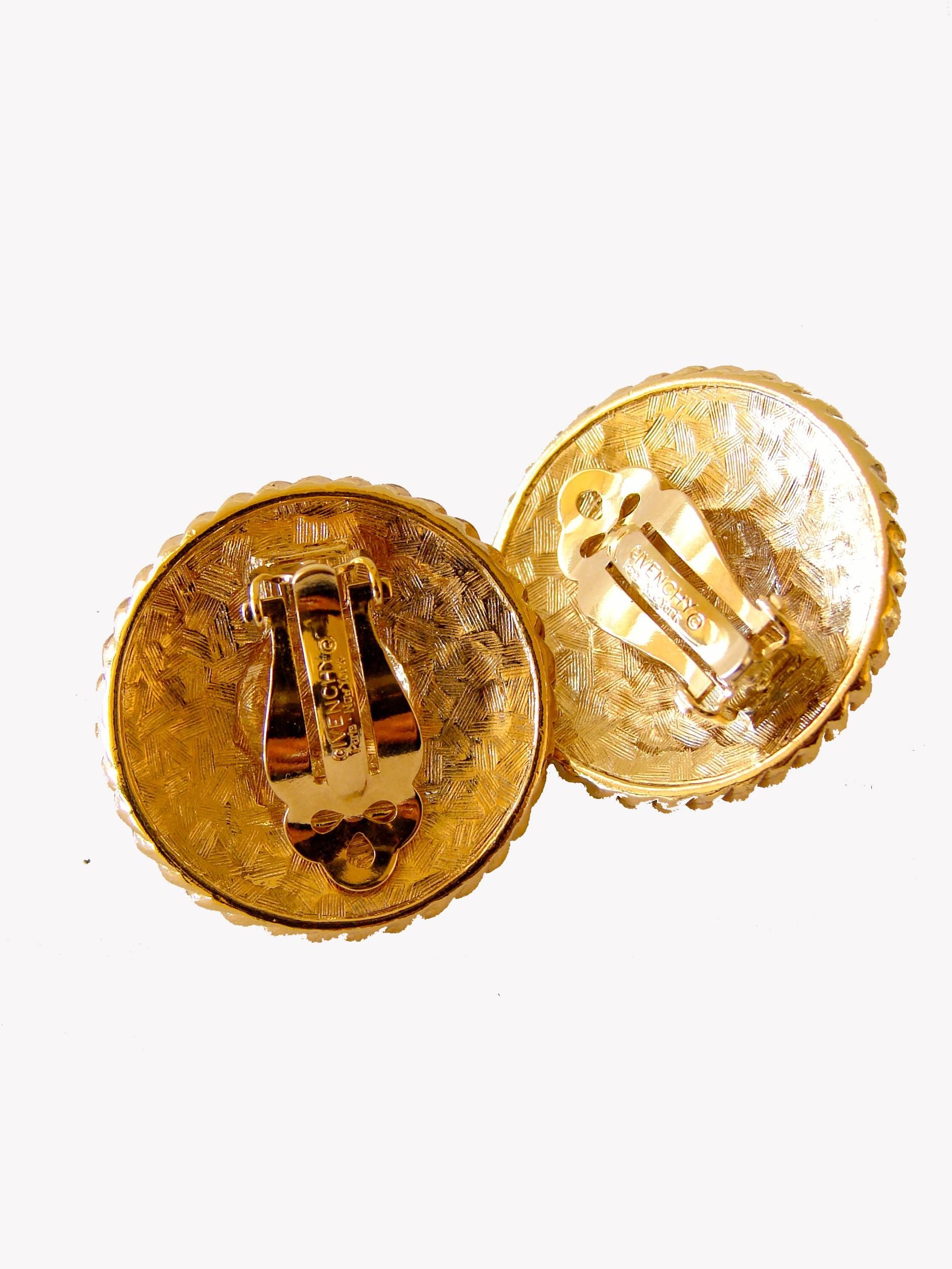 These gorgeous earrings were made by GIVENCHY c1970s.  Made from gilt metal, these feature one red poured glass cab in the center and an Etruscan style etching on the gilt metal. Clip style and in very good condition with minimal signs of prior