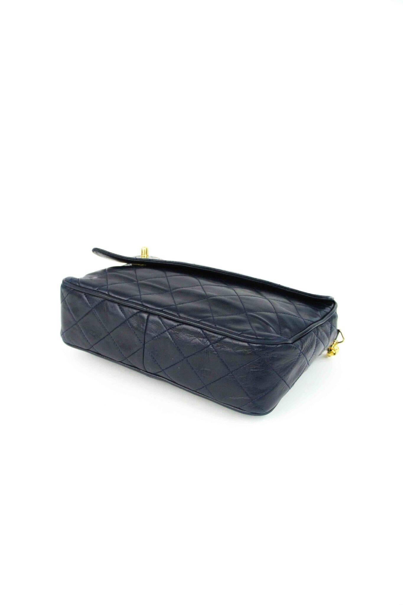 Pre-owned Vintage Chanel camera bag with signature gold CC logo . Supple quilted lambskin with gold hardware and tassel zipper pull. Authenticity guaranteed.  Supple lambskin lining.  Signature gold tone chain shoulder strap.