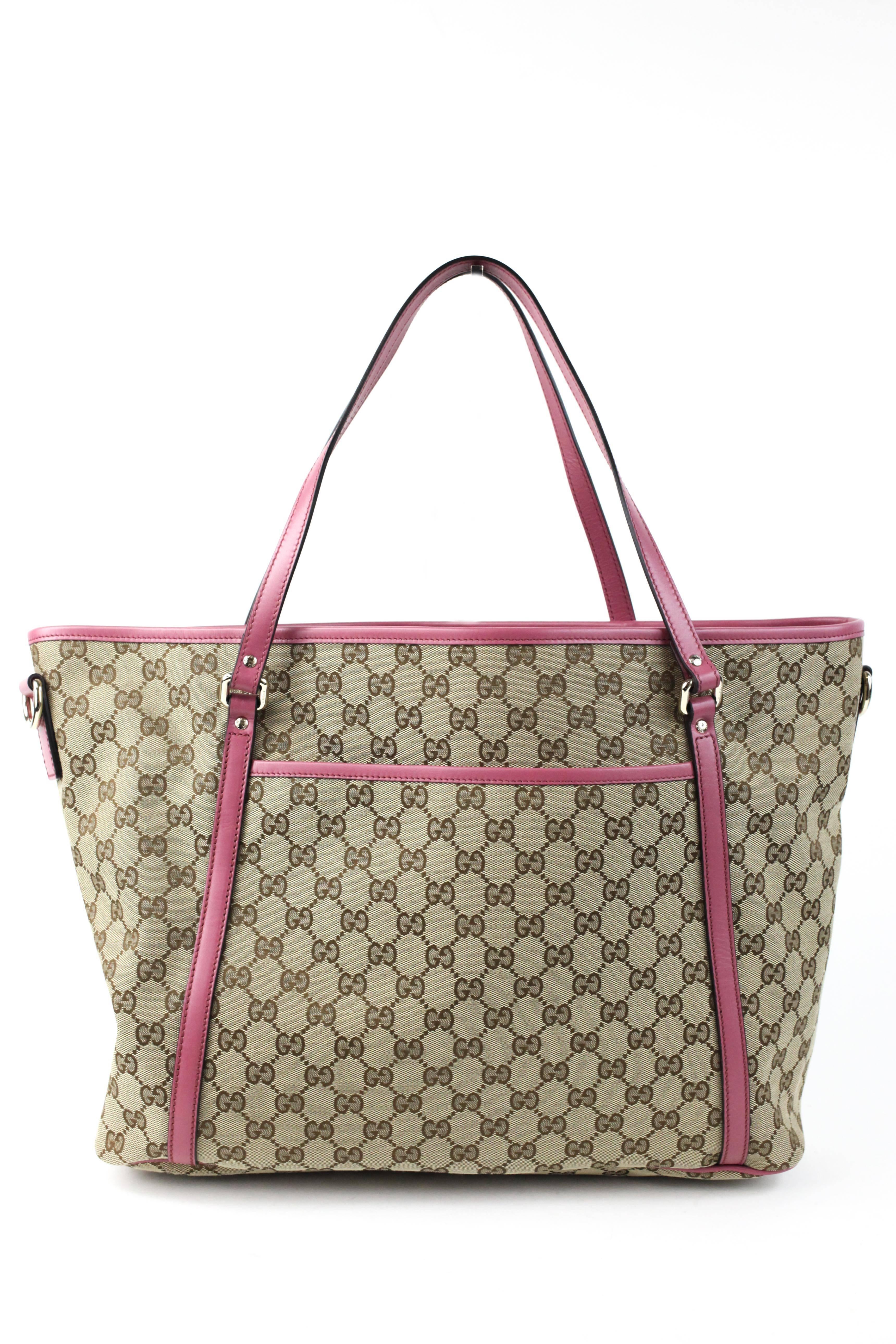 Offered is an attractive monogram Gucci logo canvas tote with mauve tone leather trim . Silver tone hardware throughout, dark fabric lining with several pockets inside , and two slip pockets on the exterior on front and back.  No signs of wear ,