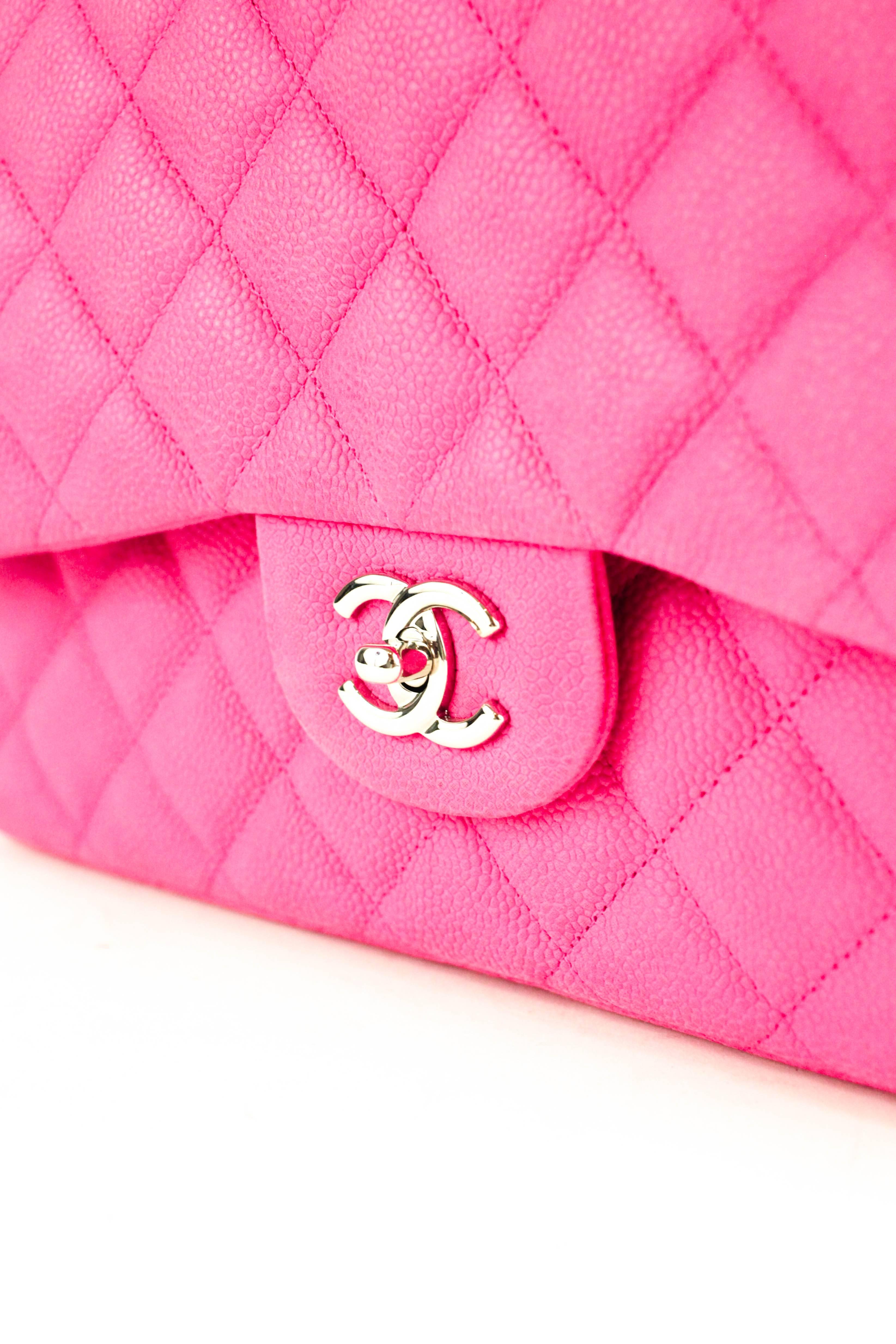 Offered is an extremely rare and unique piece from Chanel.  A striking hot pink classic double flap in the large size, with a matte caviar finish, and brilliant silver tone hardware.  Signature CC turn-lock closure on front flap, with envelope