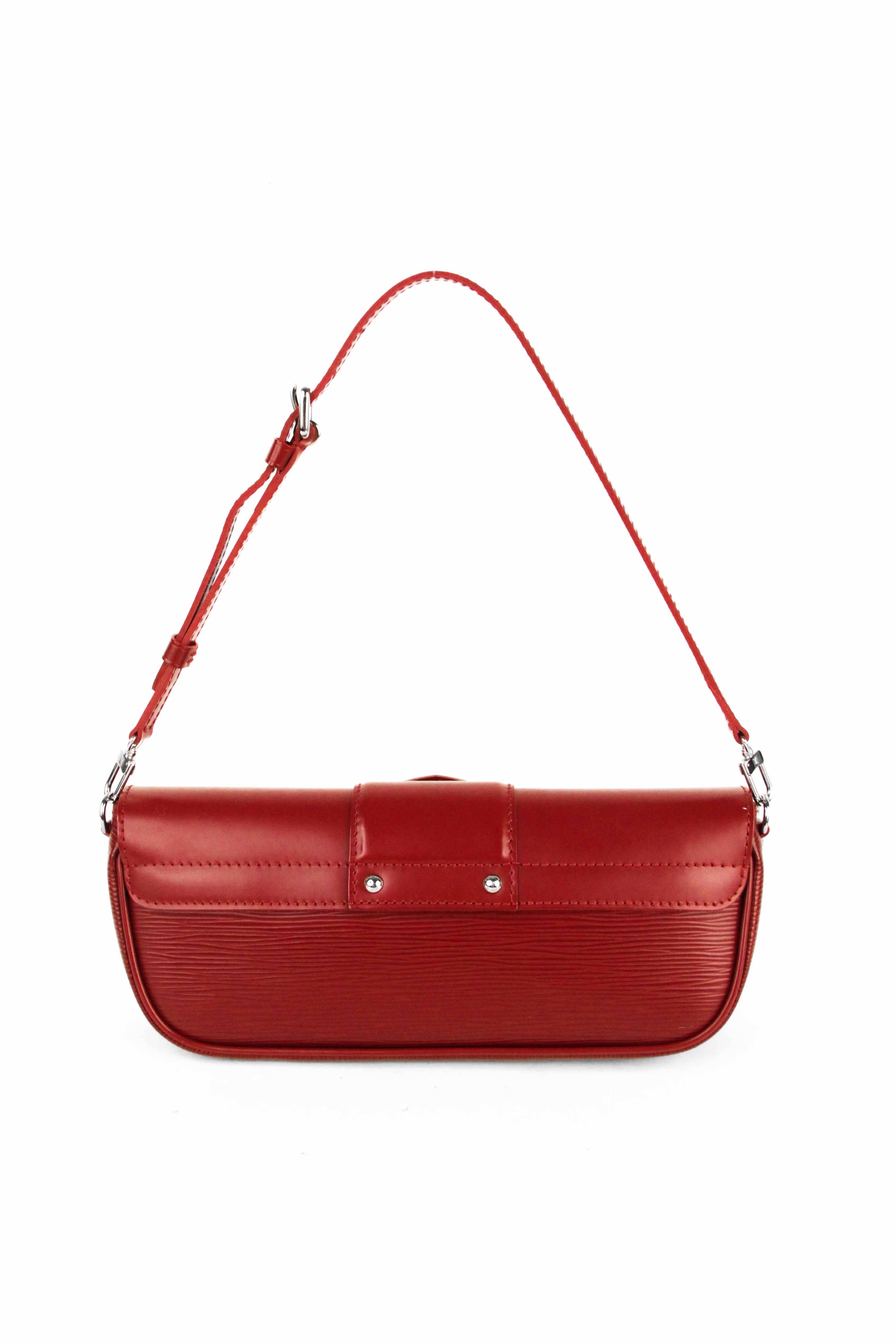 Offered is a perfect red Epi Leather Montaigne Pochette shoulder bag.  Polished silver-tone hardware with a press lock on the front flap.  Flat leather adjustable shoulder strap with silver buckle, can be removed to use bag as a pochette.  Darling